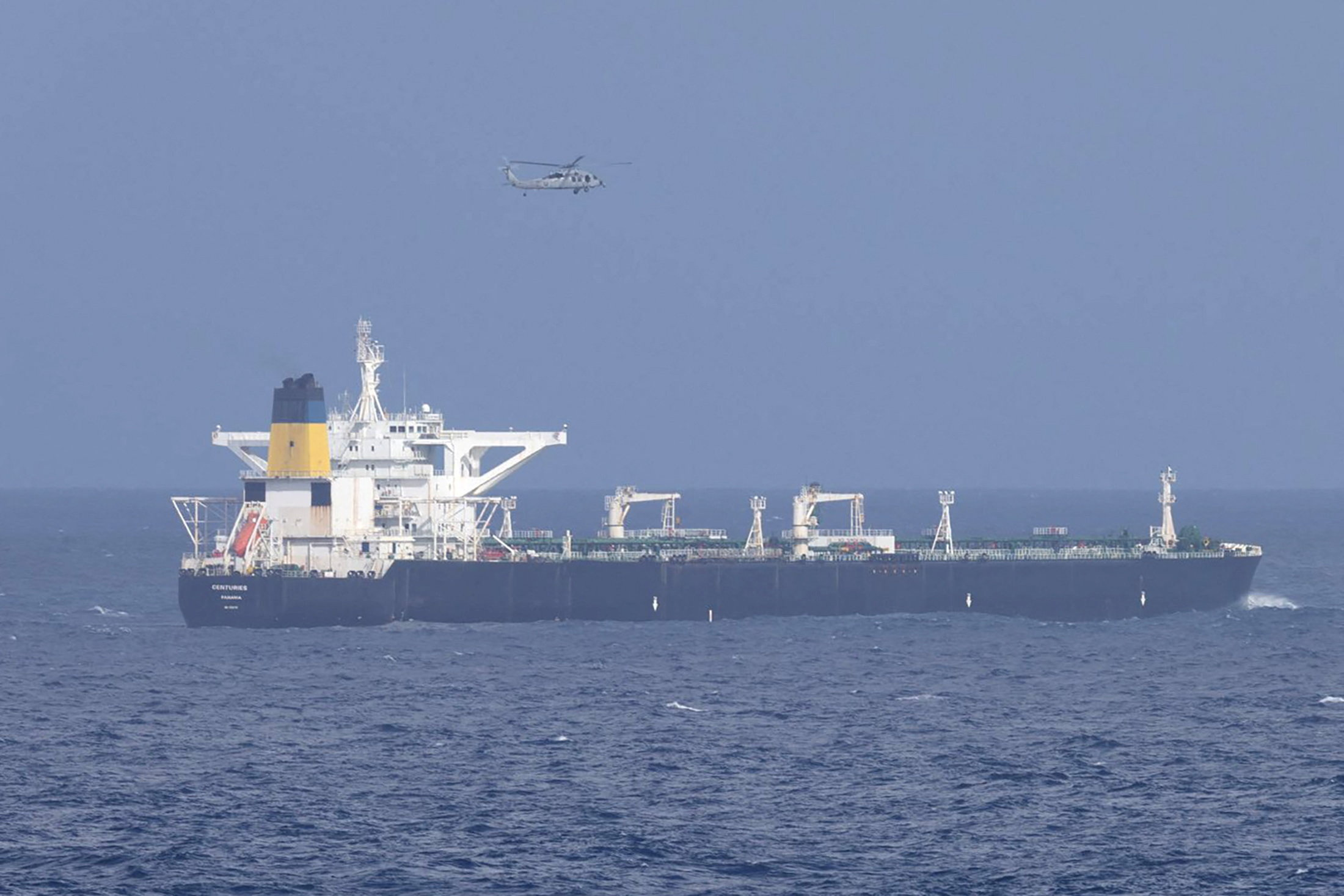 A U.S. military helicopter flies over the Panama-flagged Centuries ship.