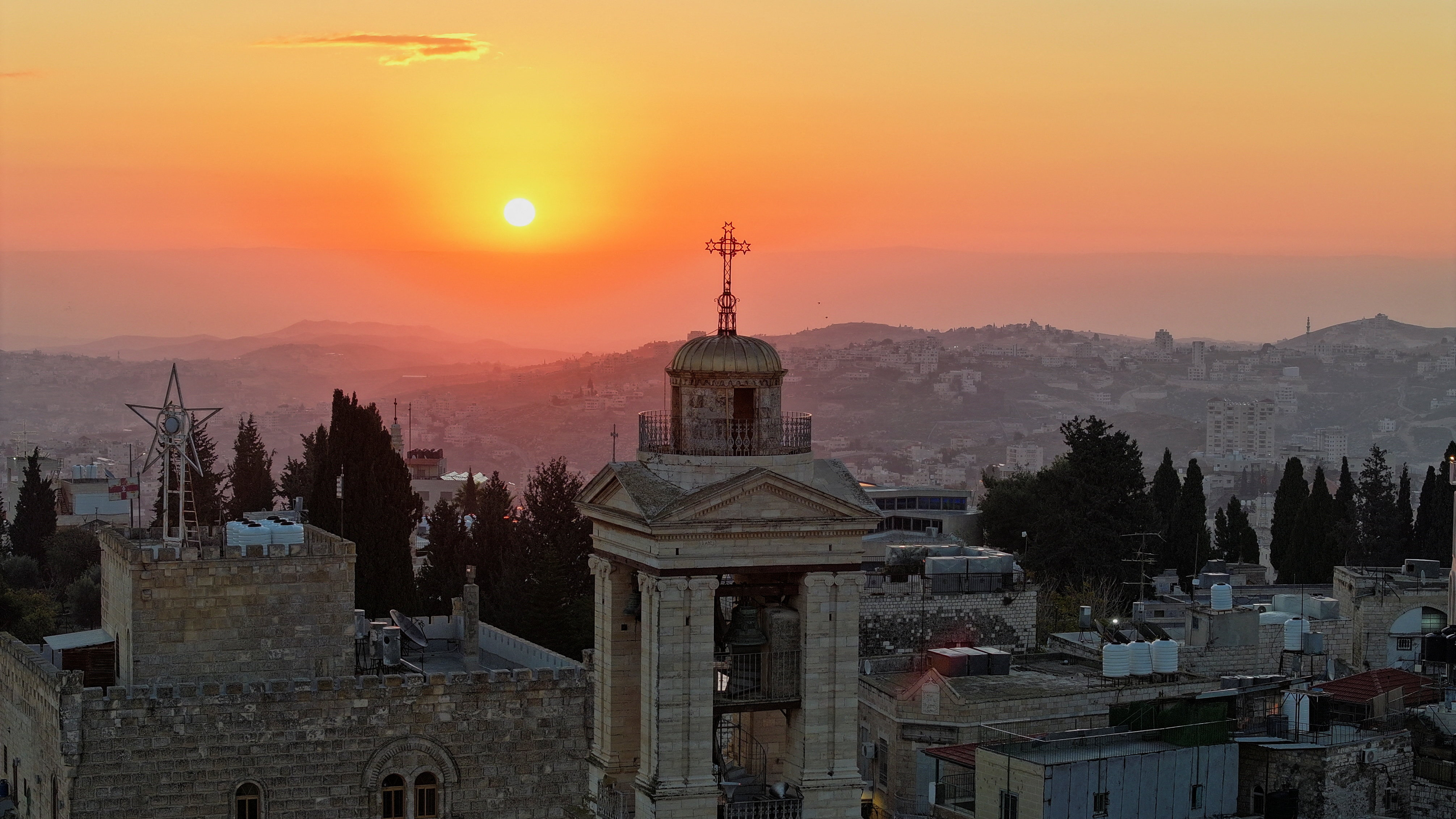 A drone view of the sun rising over the Church of the Nativity ahead of the arrival of the Latin Patriarch of Jerusalem, Cardinal Pierbattista Pizzaballa, to attend Christmas events in Bethlehem, in the Israeli-occupied West Bank, December 24, 2025. REUTERS/Yosri Aljamal