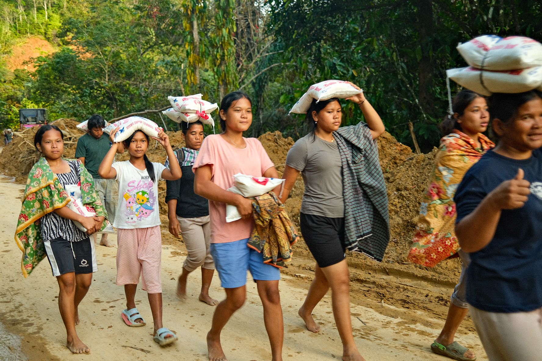 These women from Central Tapanuli said they trekked three hours from their village to North Tapanuli just to get rice. They said no aid has yet reached their community.