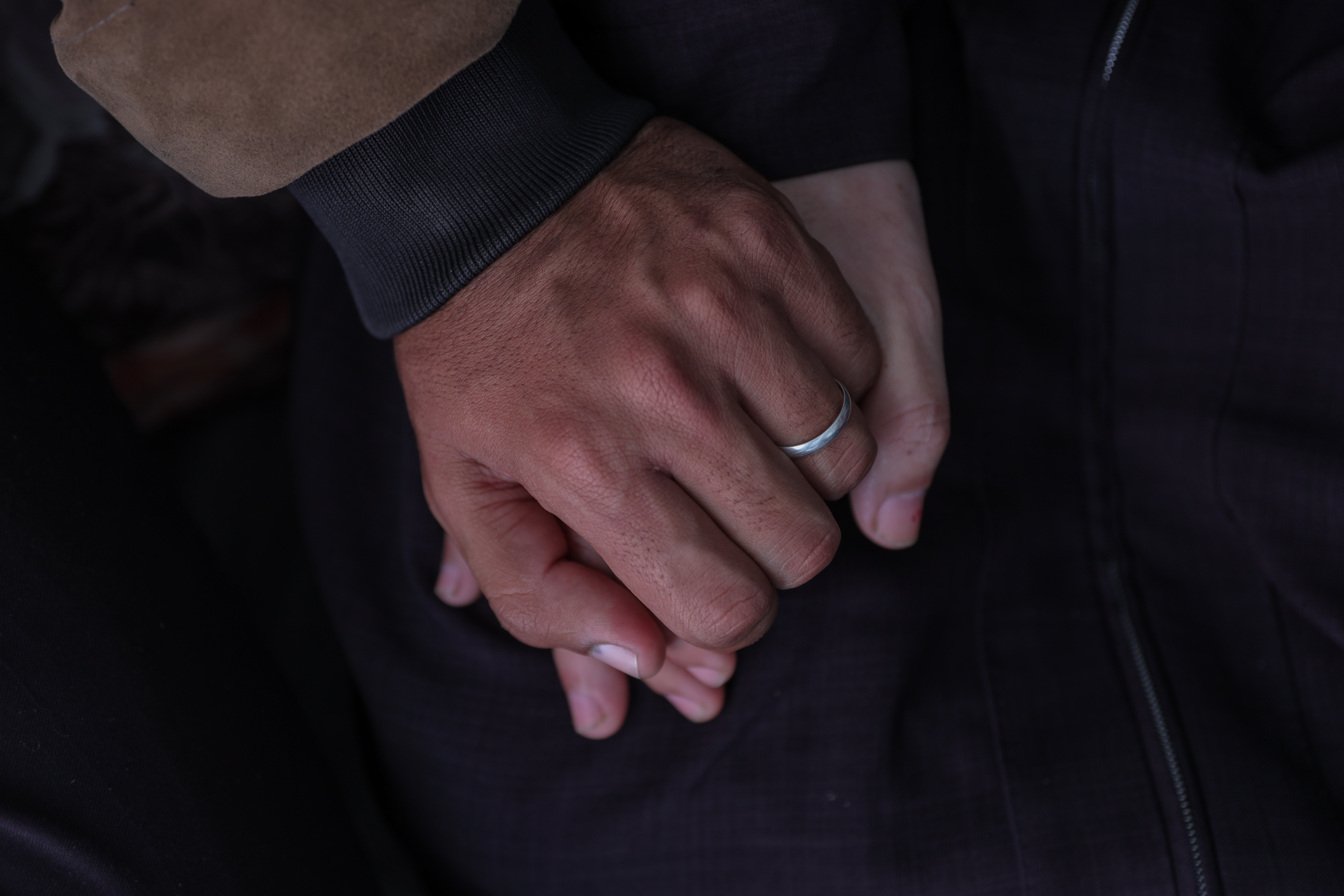 Close up of Mustafa and Nesma holding hands, with the groom's wedding ring visible