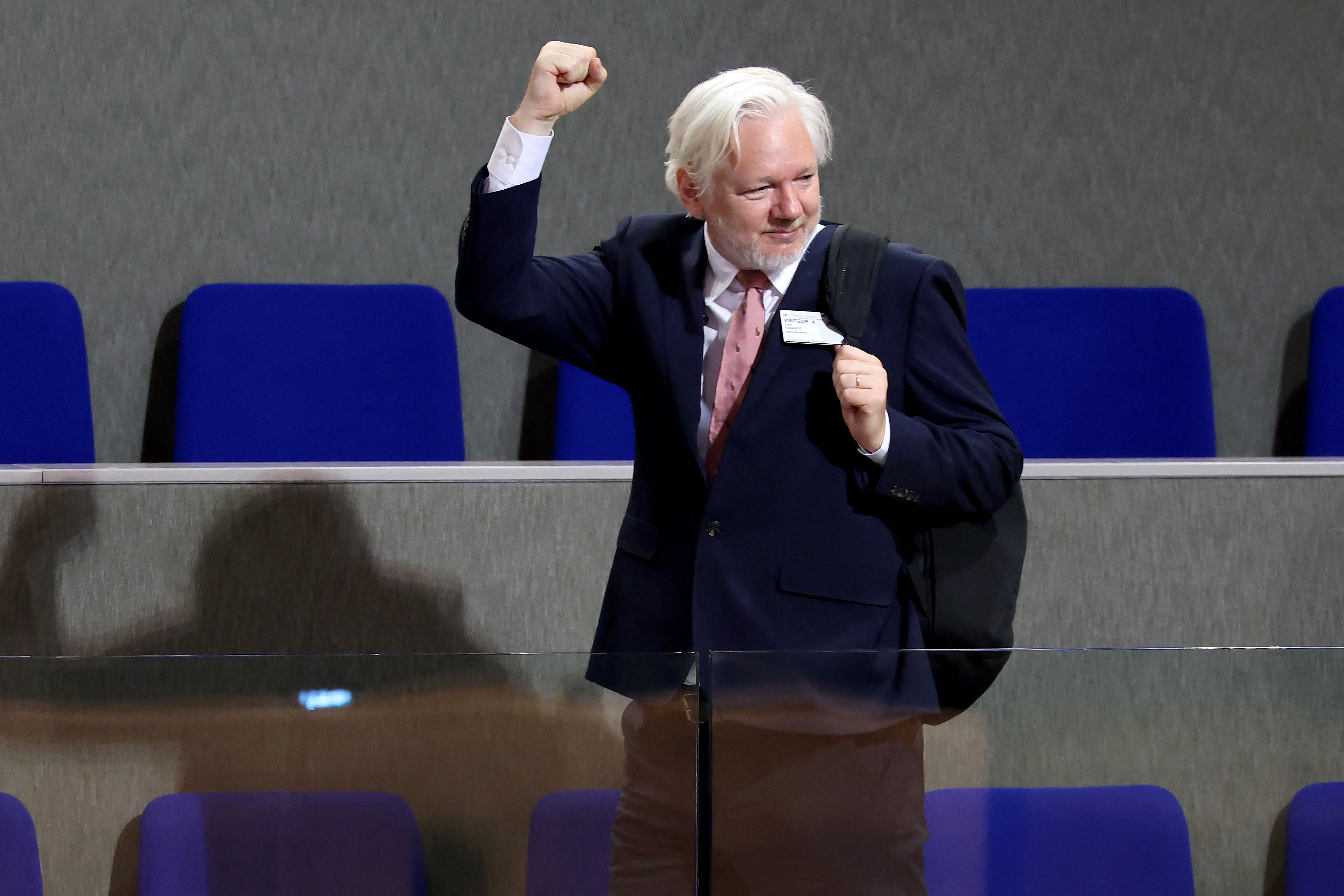 WikiLeaks founder Julian Assange raises his fist after a debate focused on his detention and conviction and their chilling effects on human rights at the Council of Europe in Strasbourg, eastern France, on October 2, 2024. Julian Assange said on October 1, 2024 he was released after years of incarceration only because he pleaded guilty to doing "journalism", warning that freedom of expression was now at a "dark crossroads". (Photo by FREDERICK FLORIN / AFP)