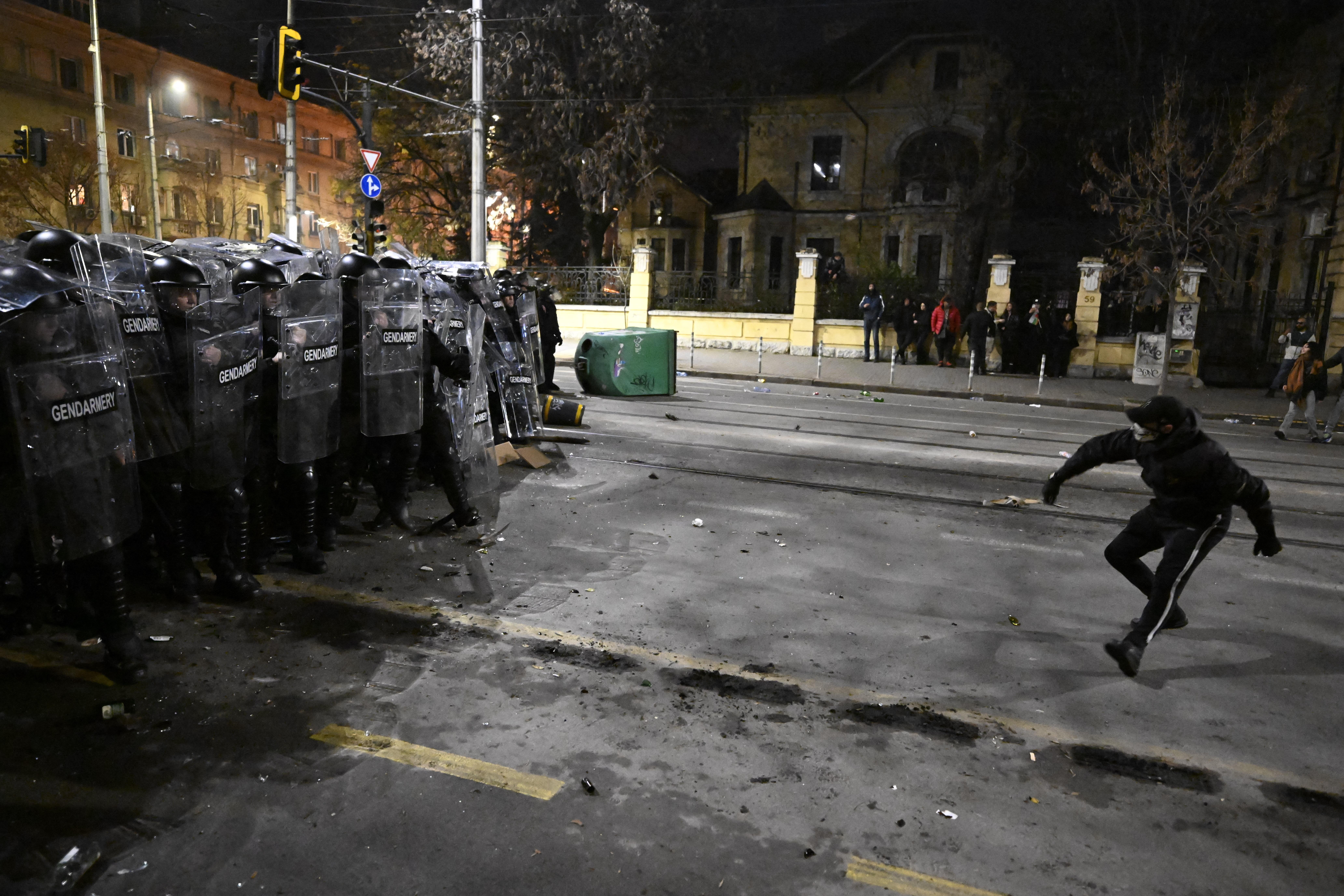 A protester clashes with Bulgarian Gendarmerie during an anti-government protest in Sofia on December 1, 2025. Tens of thousands of people held anti-government protests in Bulgaria on Monday, widening an anti-corruption movement sweeping the European Union's poorest country as it prepares to adopt the euro. (Photo by Nikolay DOYCHINOV / AFP)