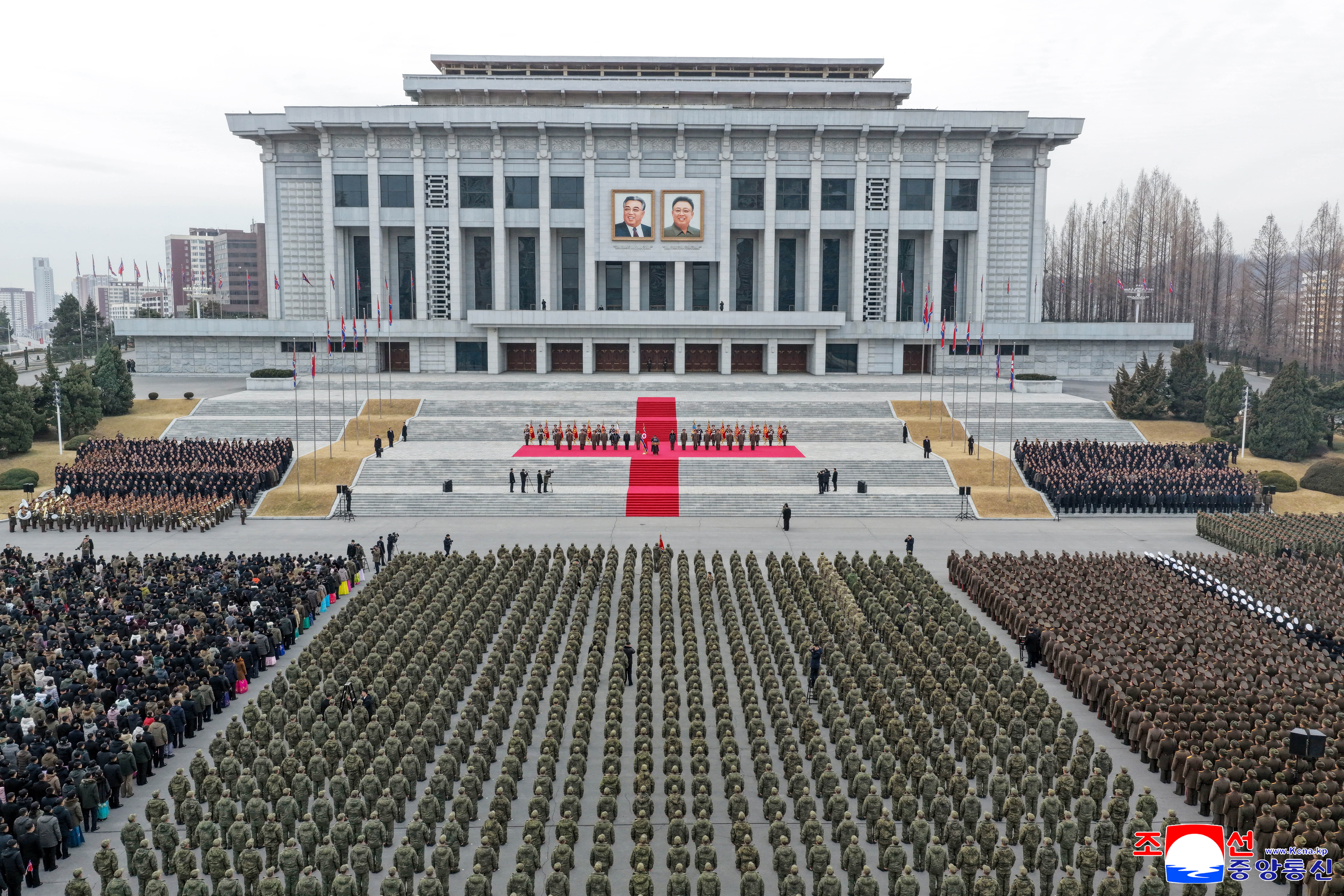 This picture taken on December 12, 2025 and released from North Korea's official Korean Central News Agency (KCNA) on December 13 shows North Korean leader Kim Jong Un (at podium) attending a welcoming ceremony for the Korean People's Army's 528th Regiment of Engineers, which returned from an overseas deployment in Russia's Kursk region during Moscow's war with Ukraine, in front of the April 25 House of Culture in Pyongyang. (Photo by KCNA VIA KNS / AFP) / South Korea OUT / SOUTH KOREA OUT / SOUTH KOREA OUT / ---EDITORS NOTE--- RESTRICTED TO EDITORIAL USE - MANDATORY CREDIT "AFP PHOTO/KCNA VIA KNS" - NO MARKETING NO ADVERTISING CAMPAIGNS - DISTRIBUTED AS A SERVICE TO CLIENTS / THIS PICTURE WAS MADE AVAILABLE BY A THIRD PARTY. AFP CAN NOT INDEPENDENTLY VERIFY THE AUTHENTICITY, LOCATION, DATE AND CONTENT OF THIS IMAGE --- /