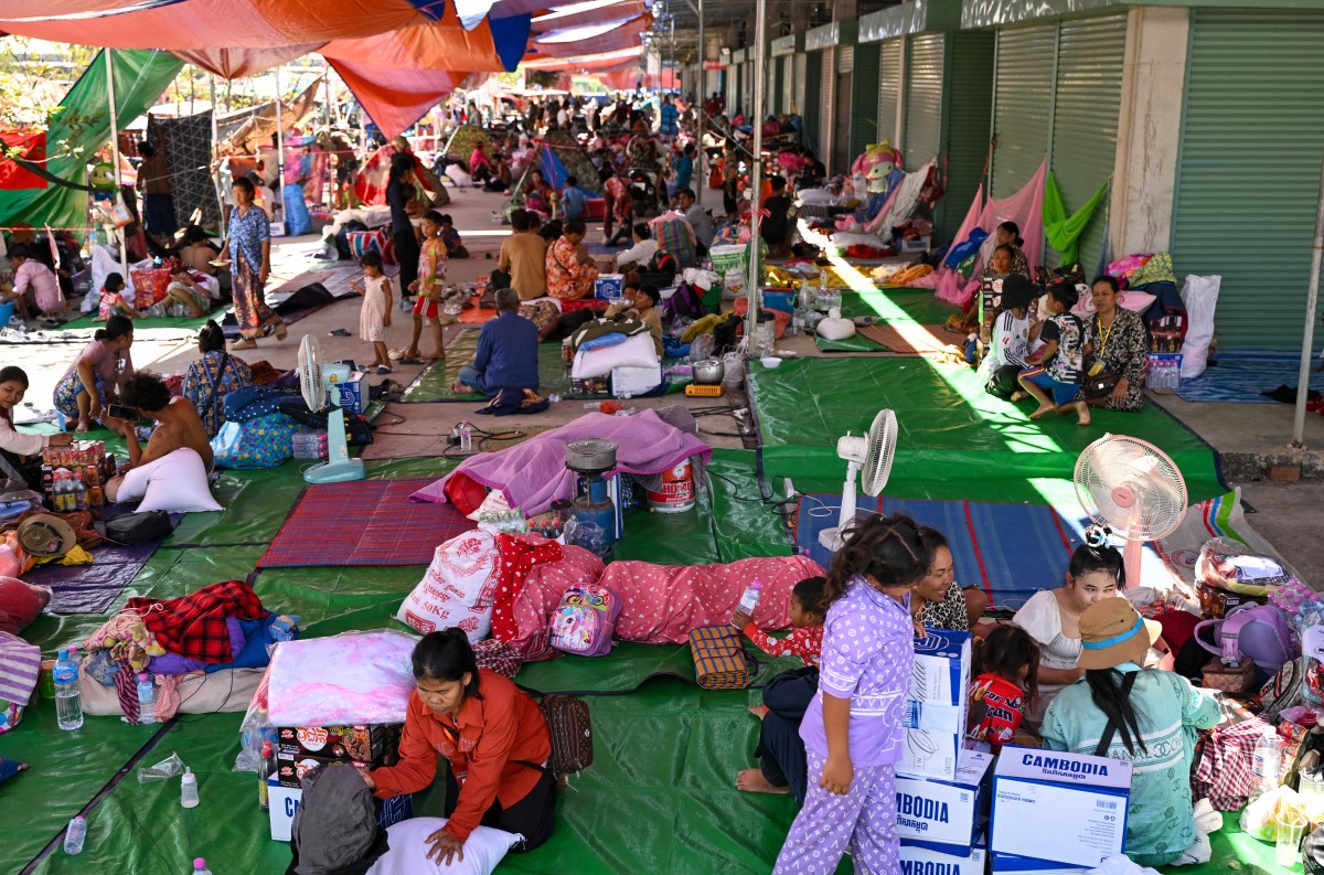 Displaced people gather at a temporary camp in Banteay Meanchey province on December 13, 2025, amid clashes along the Cambodia-Thailand border. (Photo by TANG CHHIN SOTHY / AFP)