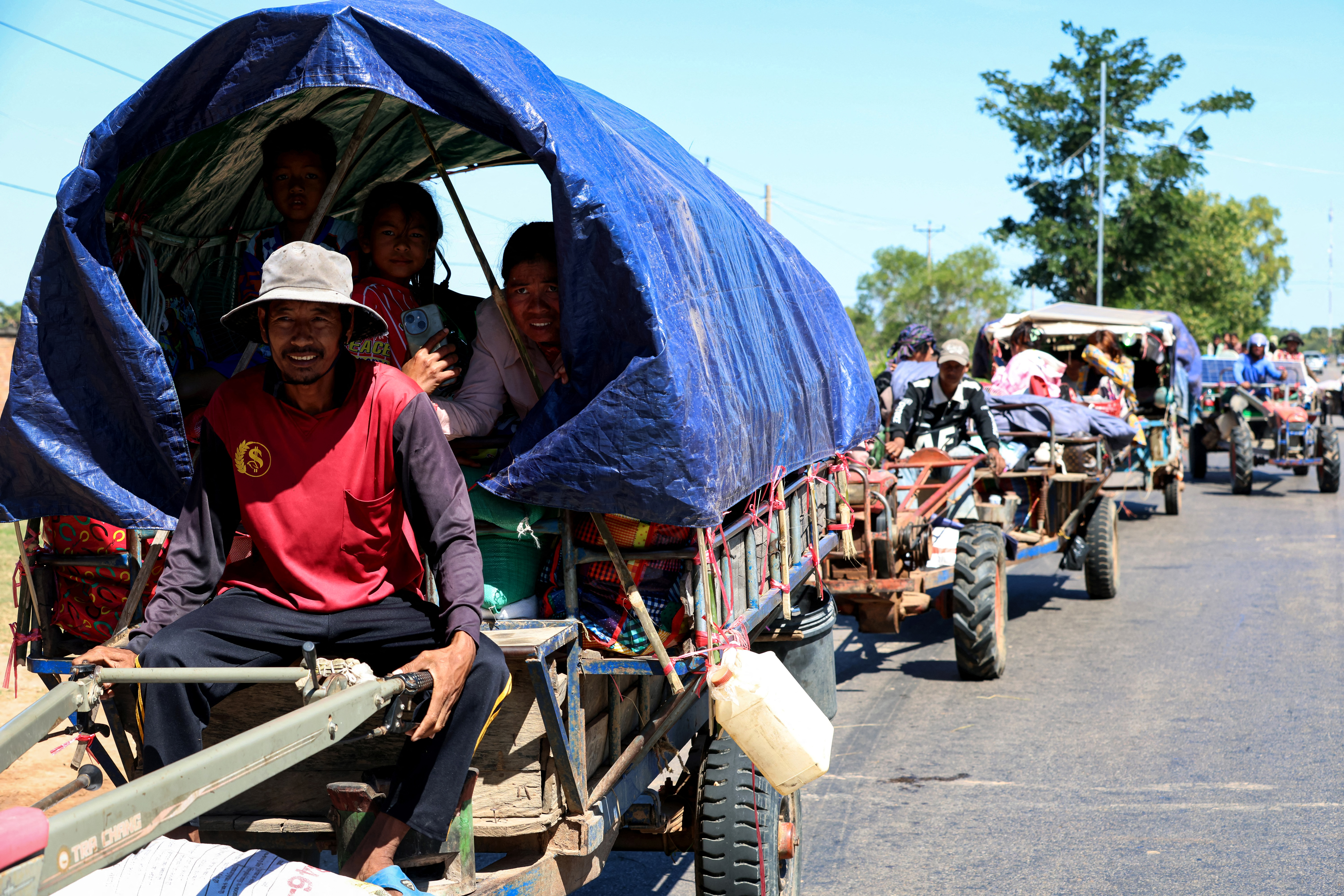 This handout photo taken and released by Agence Kampuchea Press (AKP) on December 15, 2025 shows residents evacuating following air strikes in Cambodia's Siem Reap province