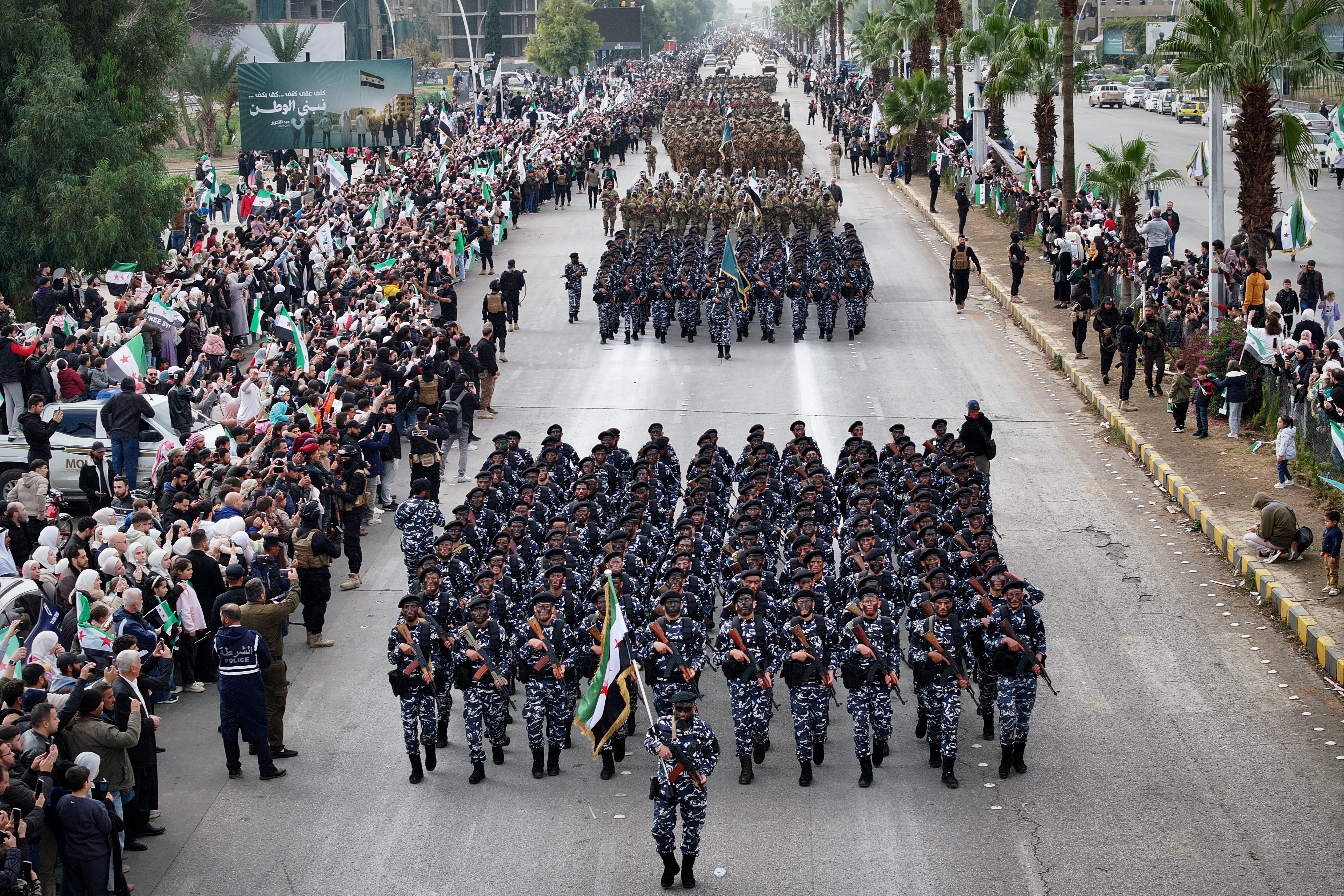 Syrian army soldiers march during a parade.