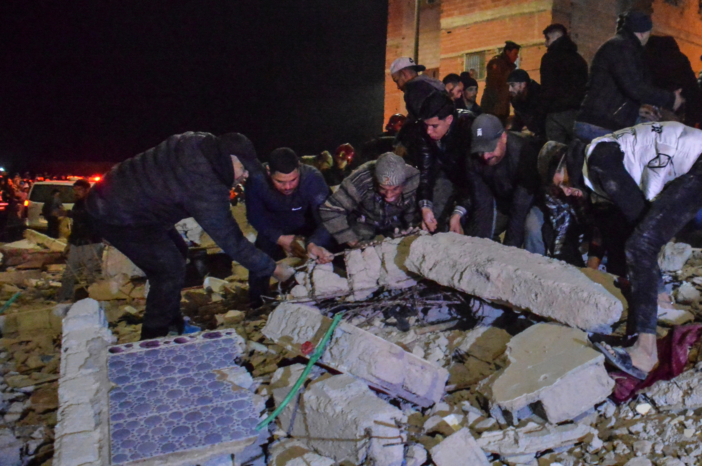 Rescue workers and residents search for survivors amid the wreckage of two collapsed buildings in Fez, Morocco, Tuesday, Dec. 9, 2025. [Ahmed Alaoui Mrani/AP Photo]