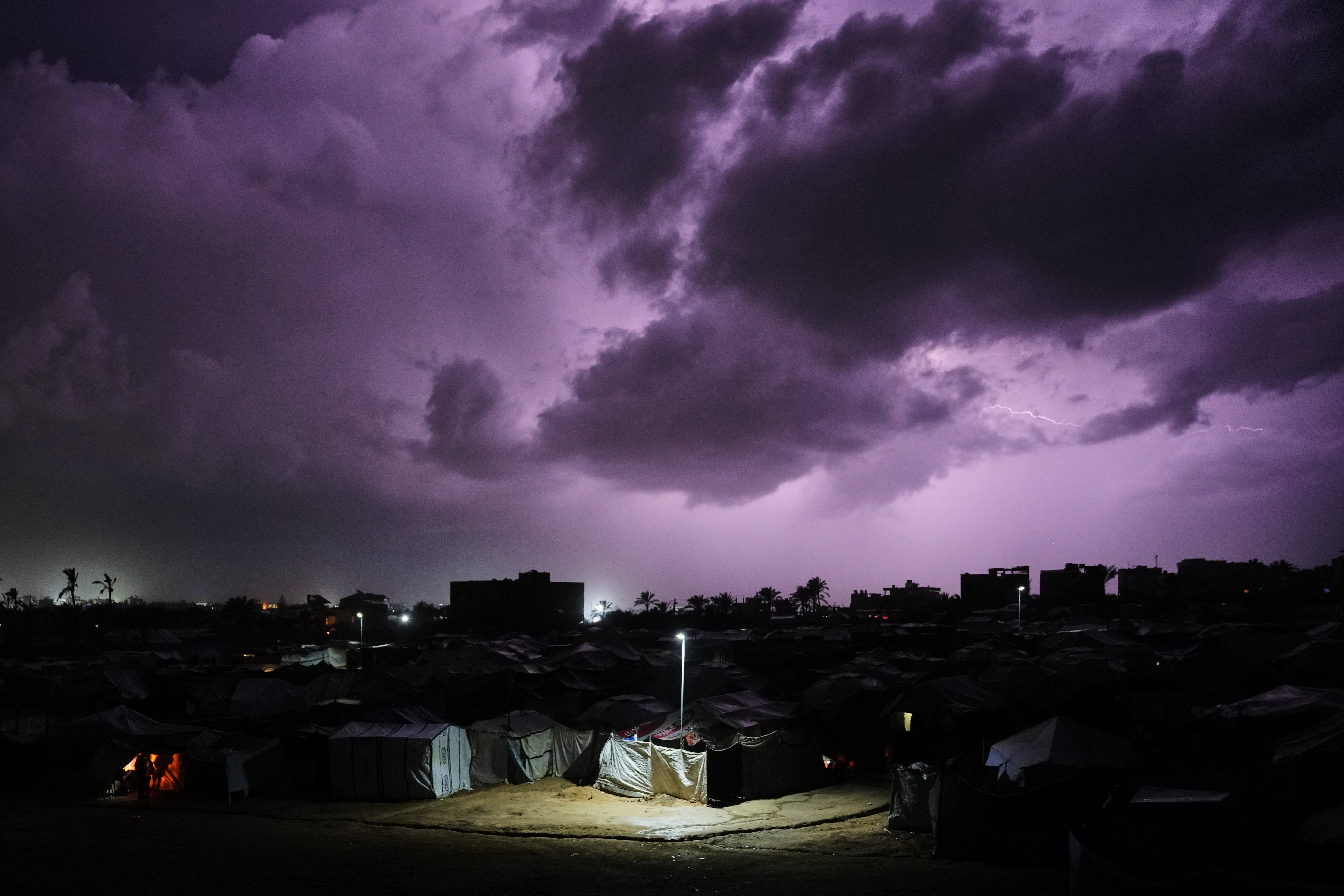 A thunderstorm is seen over a tent camp for displaced Palestinians in az-Zawaida, central Gaza Strip, Wednesday, Dec. 10, 2025. [Abdel Kareem Hana/AP]