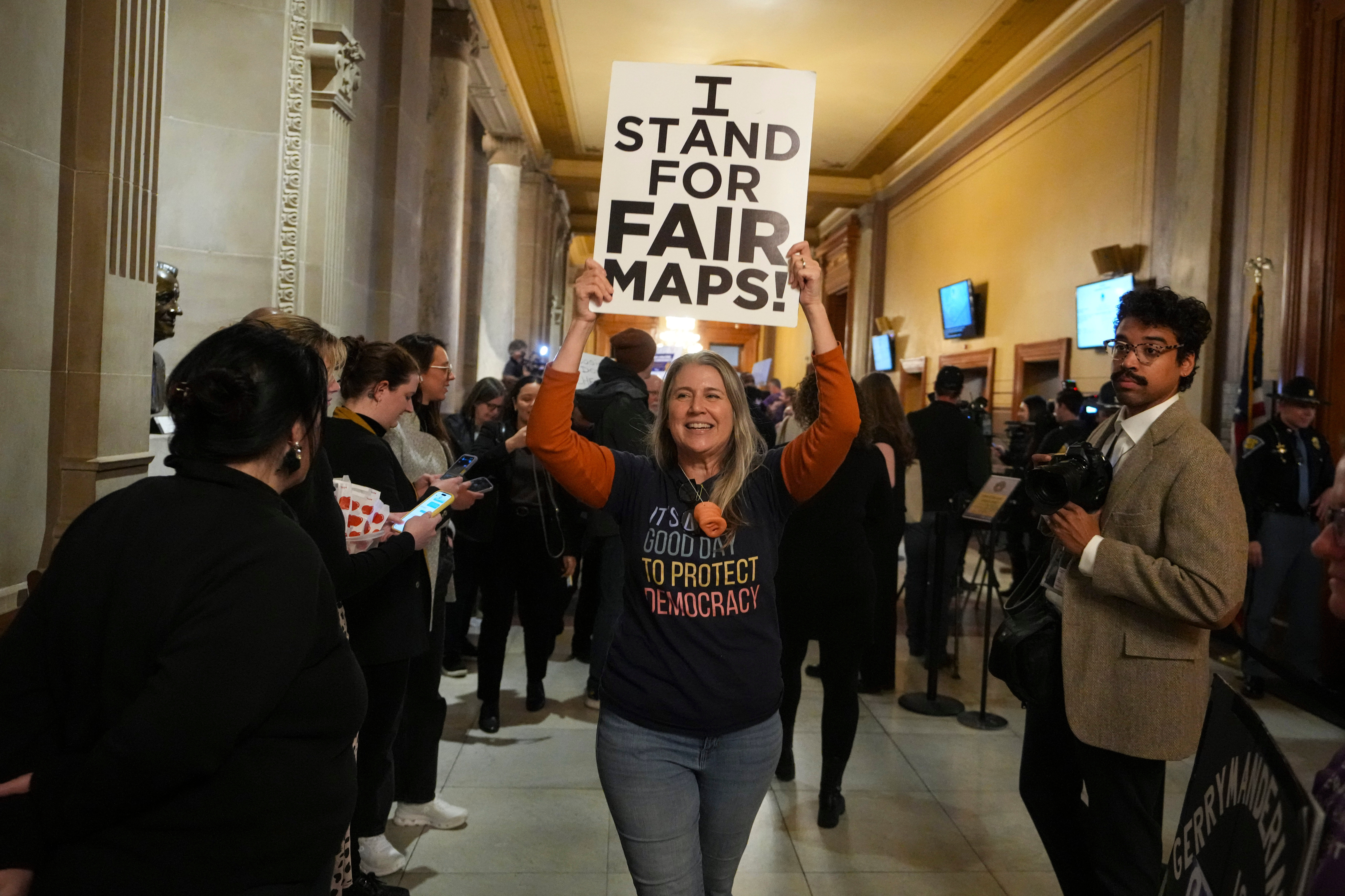 A protester holds up a sign that reads, "I stand for fair maps."