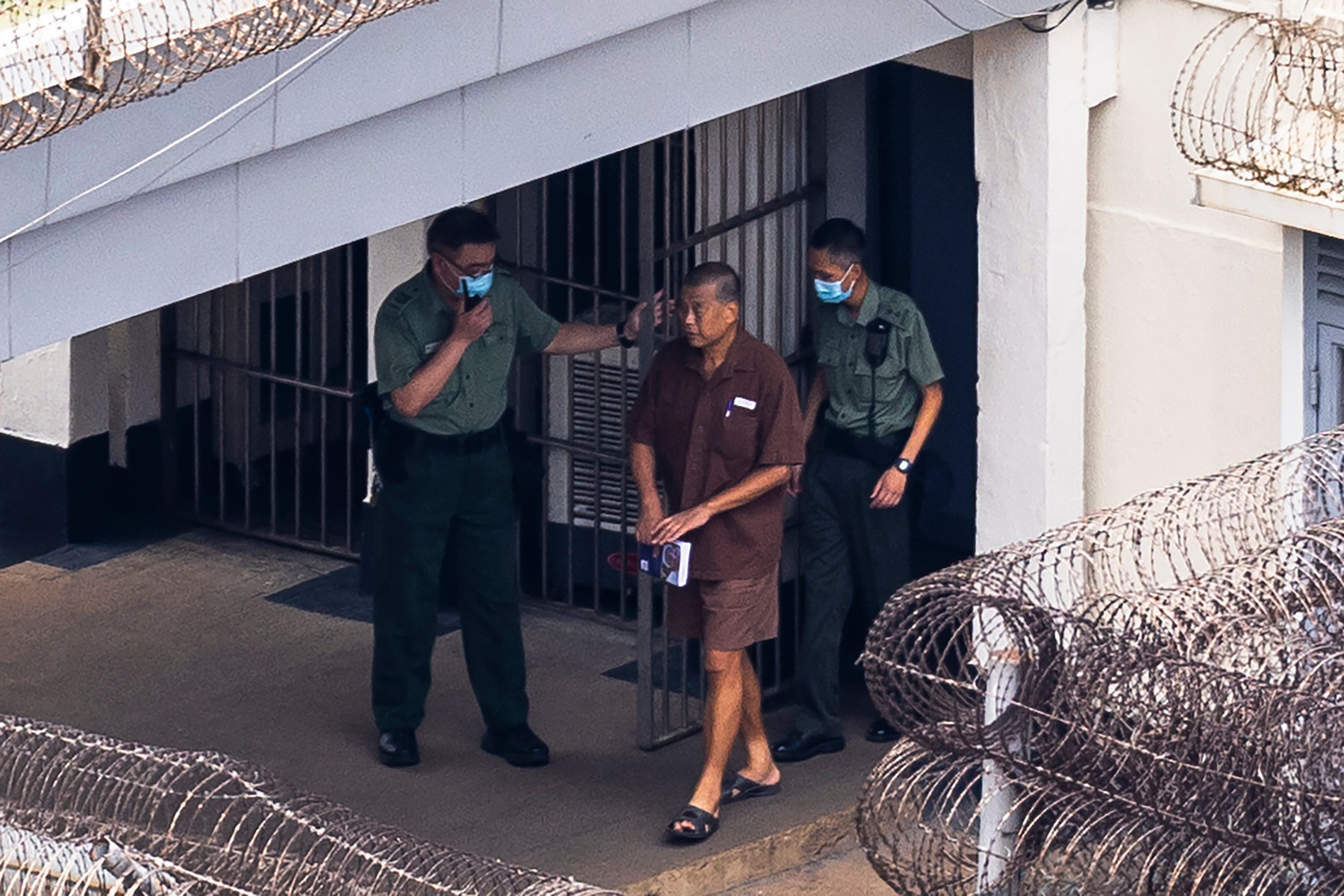 Jimmy Lai escorted from Stanley Prison