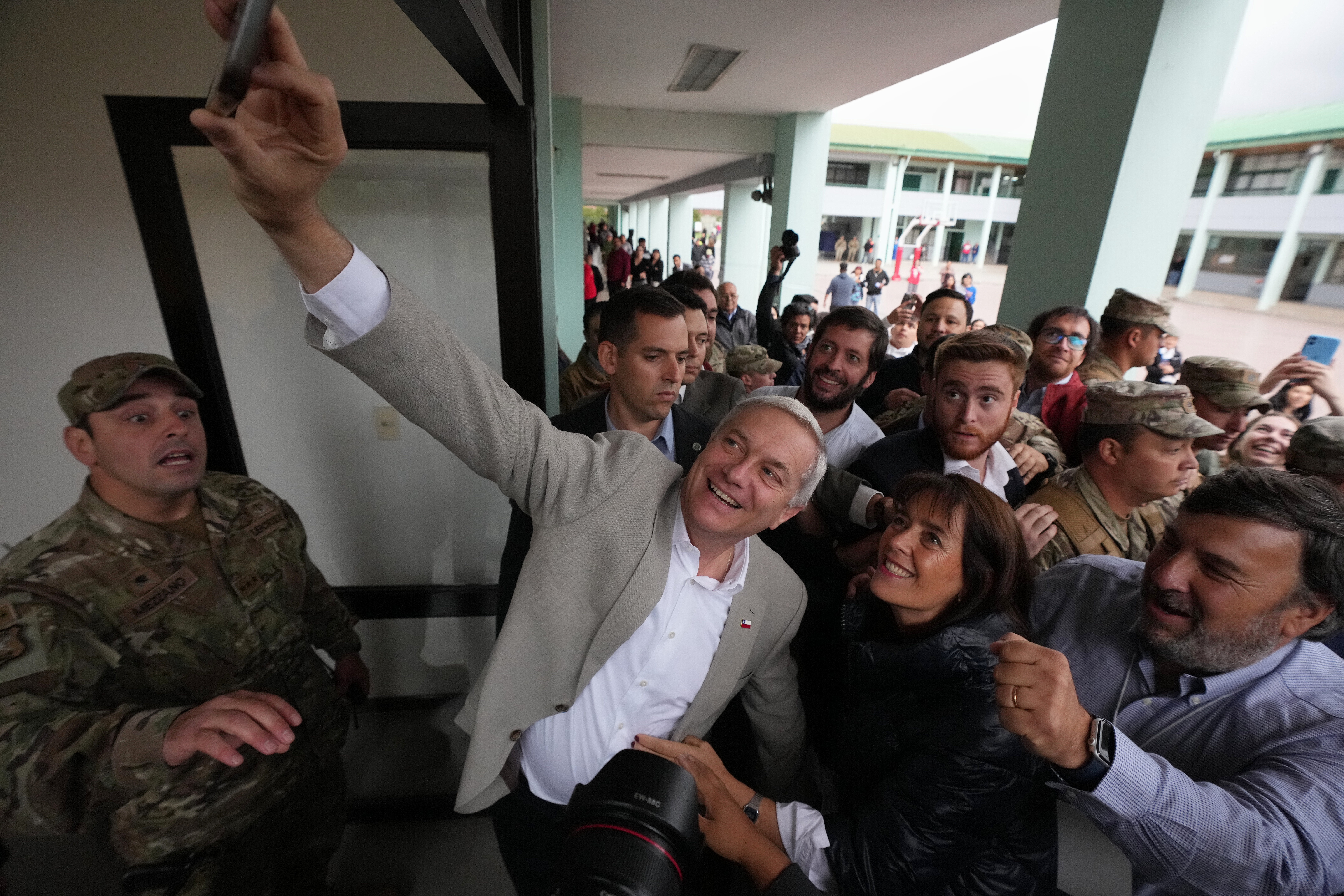 Jose Antonio Kast takes a selfie with supporters.