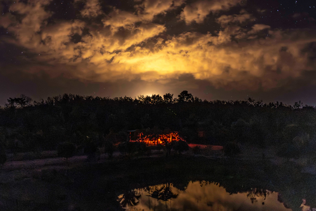 Flames are seen in Cambodia as Thai military forces fire a flare