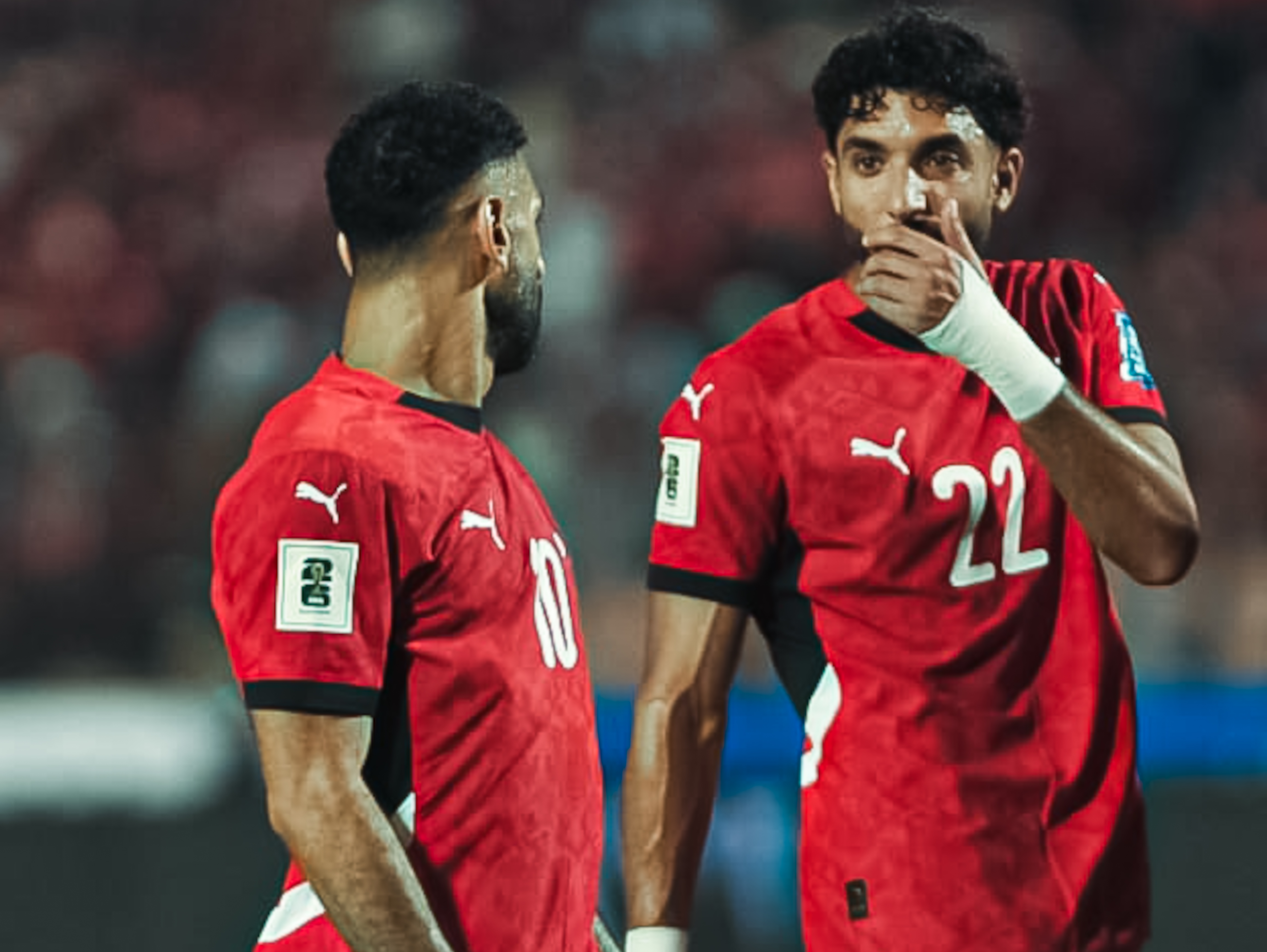 Omar Marmoush and Mohamed Salah react.