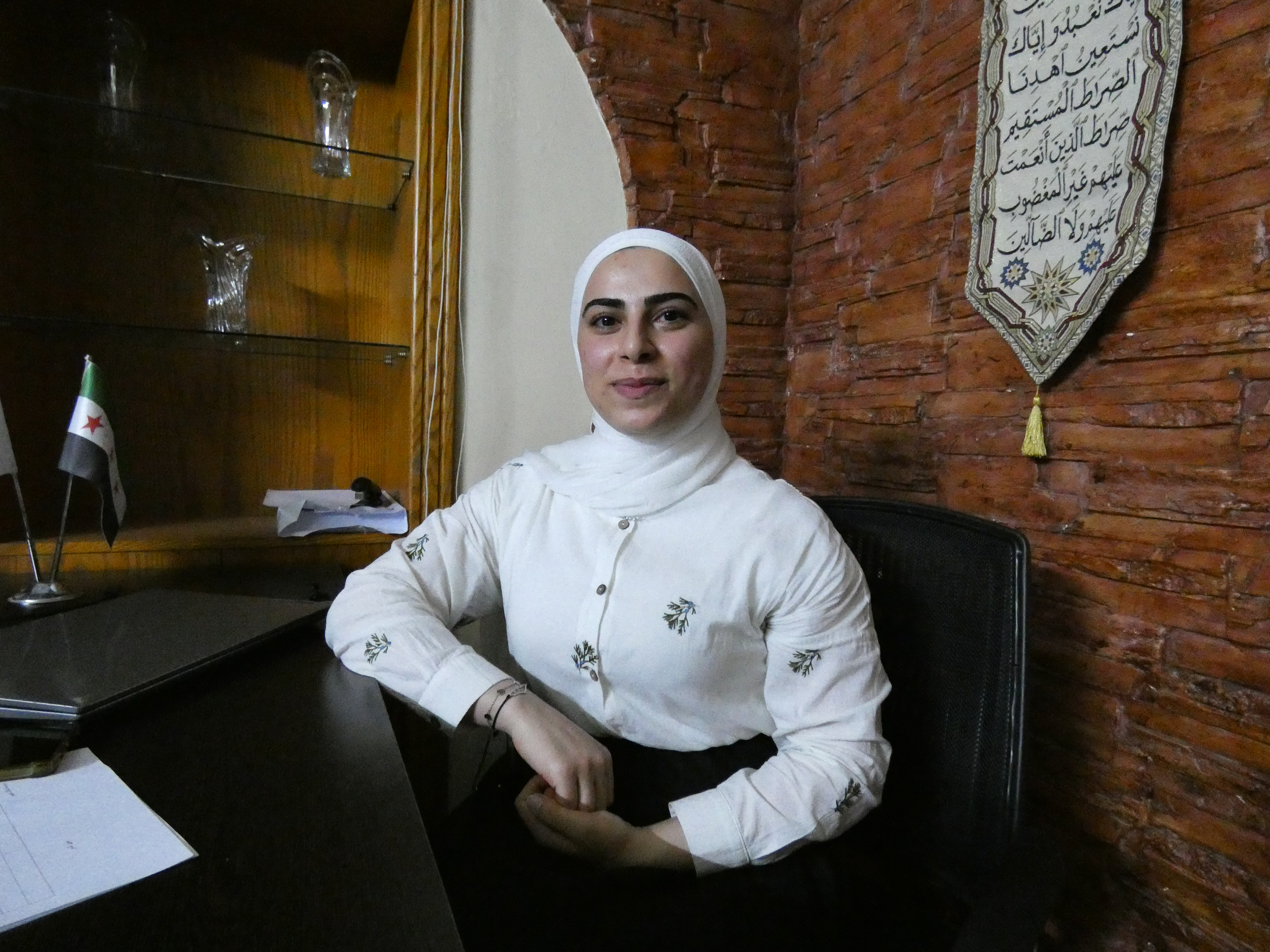 Fouziah, 23, sits behind a desk after a meeting with the Caesar Families Association. [Photo: Supplied]