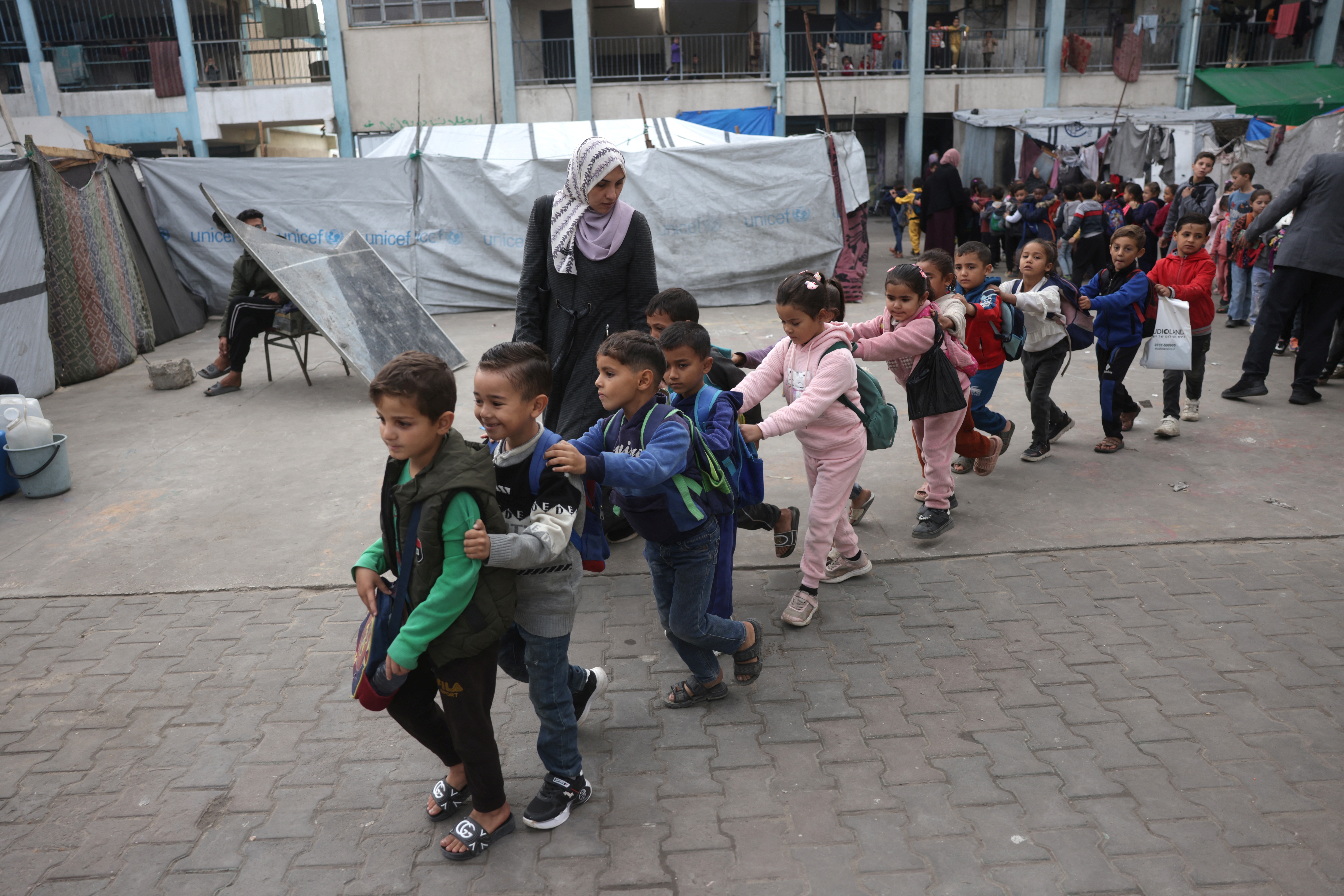 Palestinian children gather in a schoolyard.