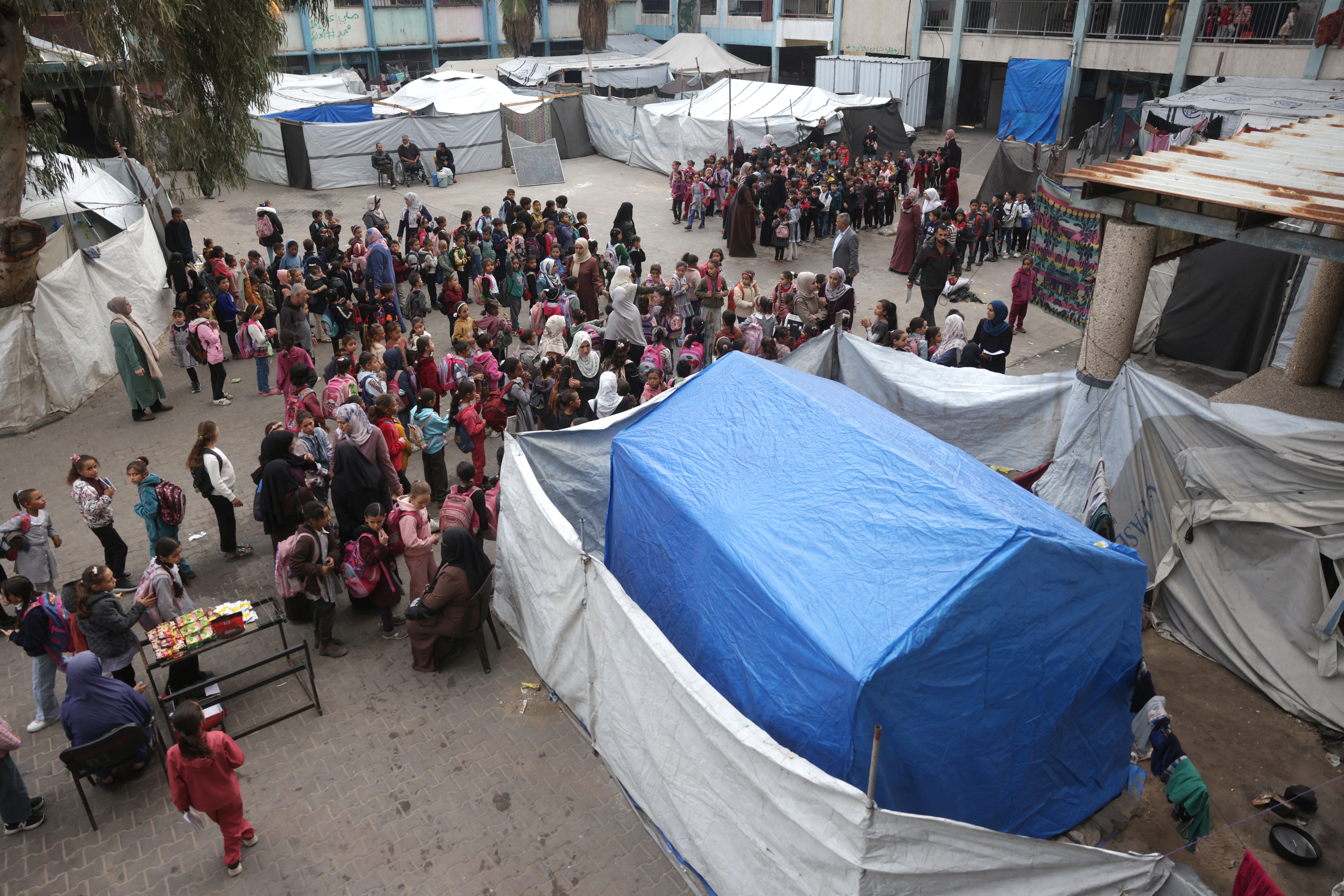 Palestinian children, mostly from displaced families, gather at an UNRWA school west of Deir el-Balah in the central Gaza Strip