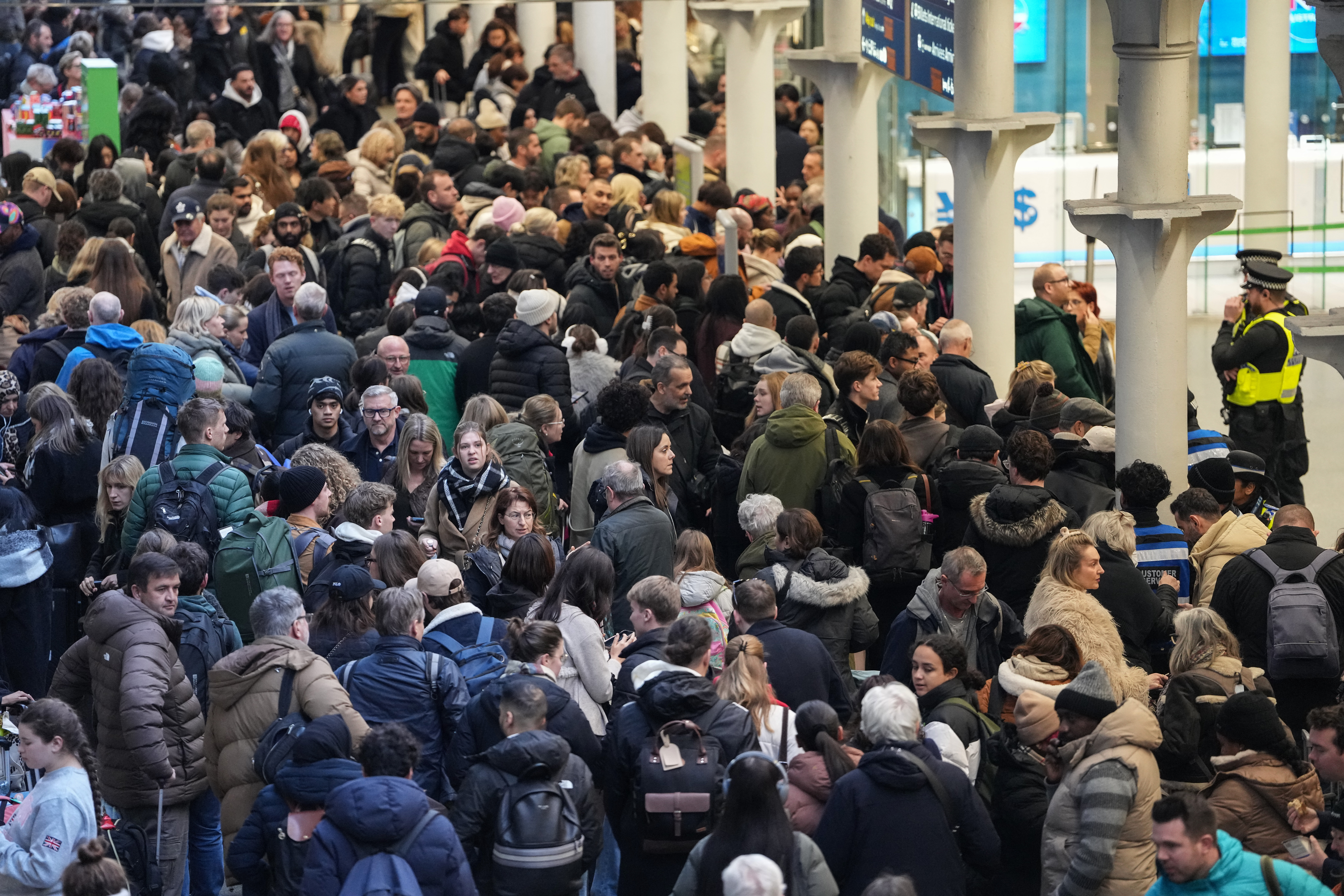 Travellers are pictured at St. Pancras station in London on December 30, 2025, as Eurostar train service between Britain and continental Europe is halted.
