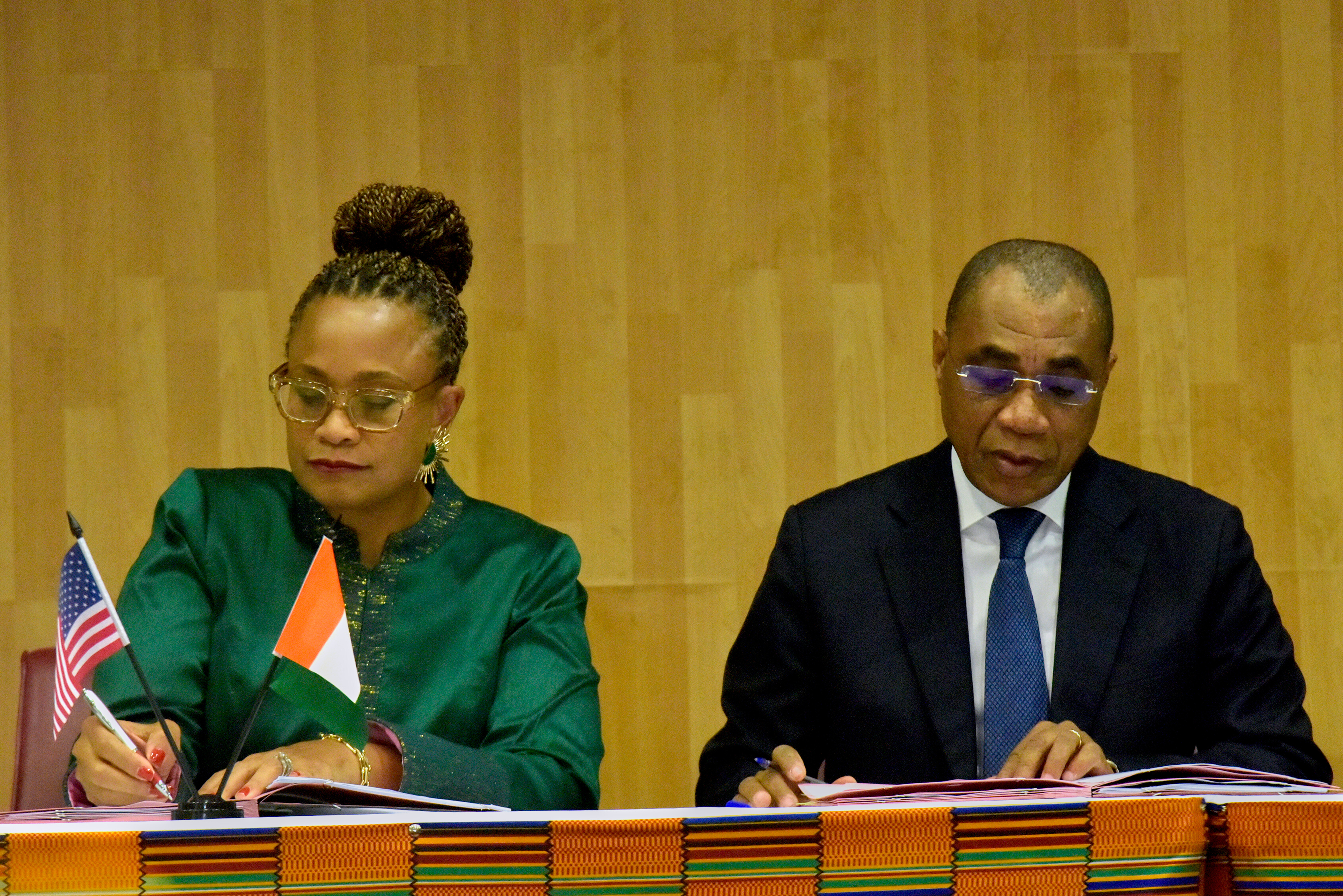 U.S. Ambassador to the Ivory Coast Jessica Davis Ba, left, and Adam Coulibaly, minister of finance and budget, sign a health agreement in Abidjan, Ivory Coast, Tuesday, Dec. 30, 2025. (AP Photo/Diomande Ble Blonde)