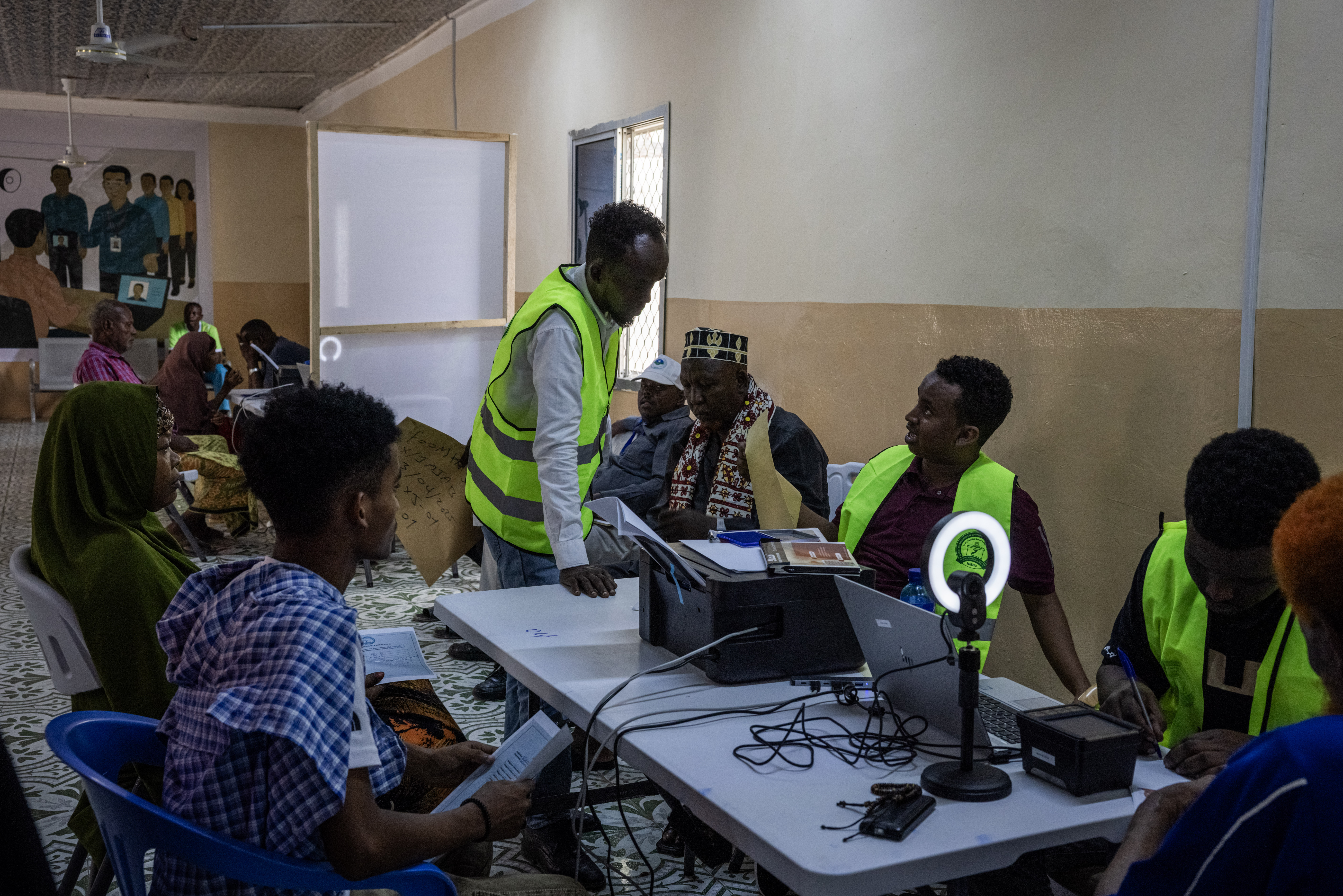 MOGADISHU, SOMALIA - APRIL 23: People have their photos, finger prints and details taken as they are registered to vote in a voting registration run by the National Independent Electoral Boundaries Commission poster on April 23, 2025 in Mogadishu, Somalia. The country launched the first voter registration drive in over 50 years ahead of presidential elections planned for 2026. The country has long used an indirect, clan-based voting system, but its current president has pledged to implement a one-person, one-vote model. (Photo by Ed Ram/Getty Images)
