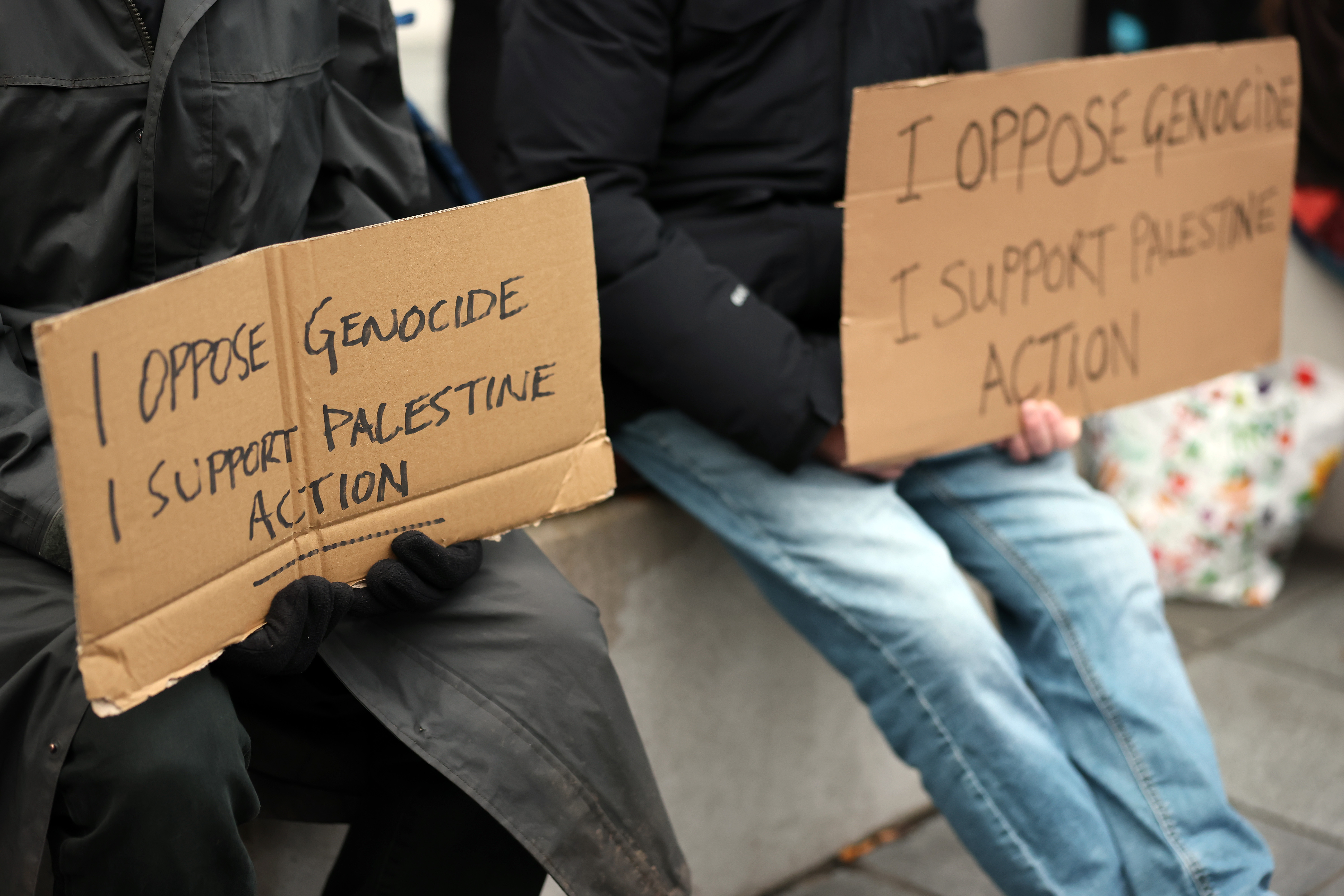 CARDIFF, WALES - NOVEMBER 29: Protesters hold signs reading "I oppose Genocide, I support Palestine Action" outside the stadium prior to the Quilter Nations Series 2025 rugby international match between Wales and South Africa at Principality Stadium on November 29, 2025 in Cardiff, Wales. (Photo by Dan Mullan/Getty Images)