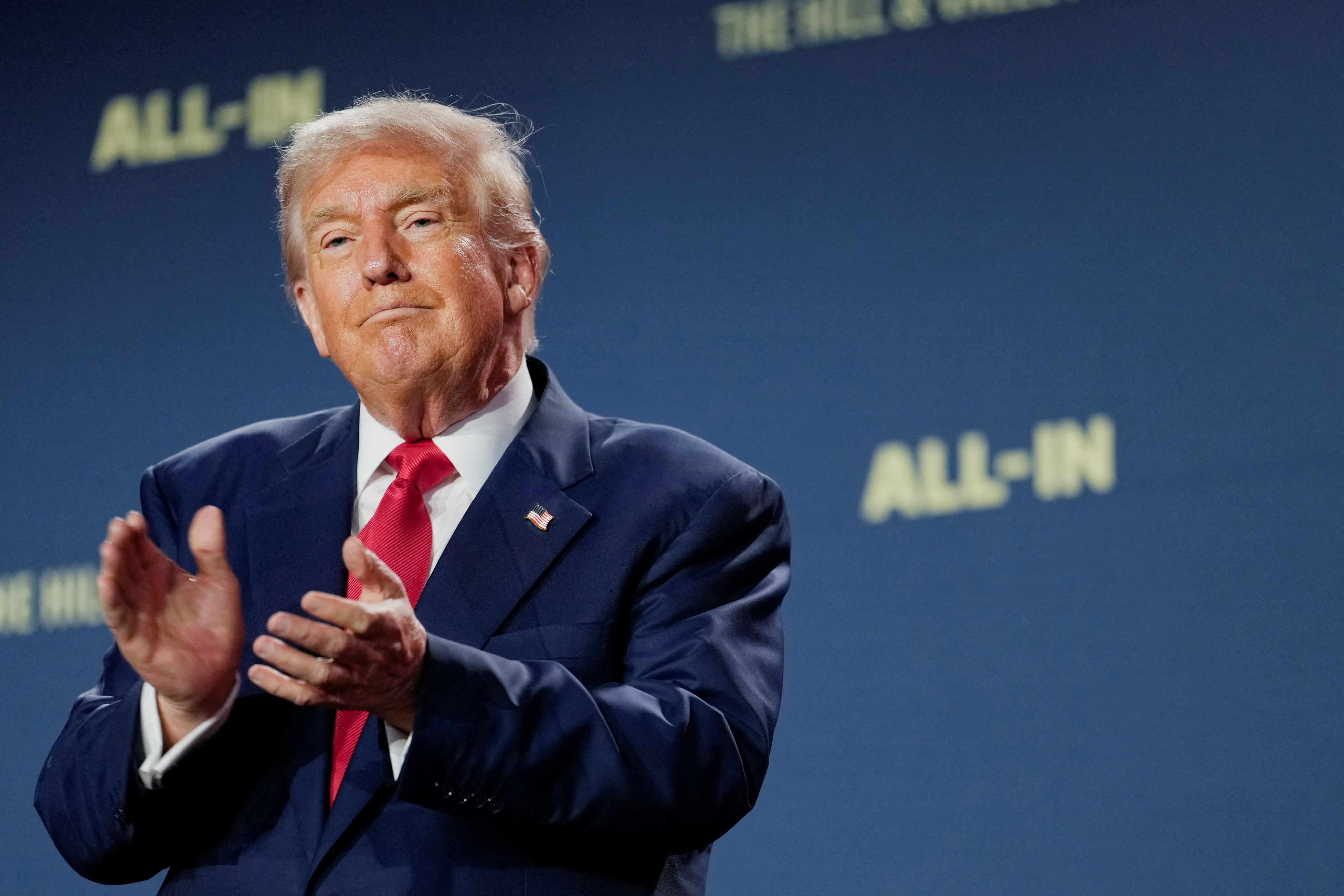 FILE PHOTO: U.S. President Donald Trump applauds at the "Winning the AI Race" Summit in Washington D.C., U.S., July 23, 2025. REUTERS/Kent Nishimura/File Photo