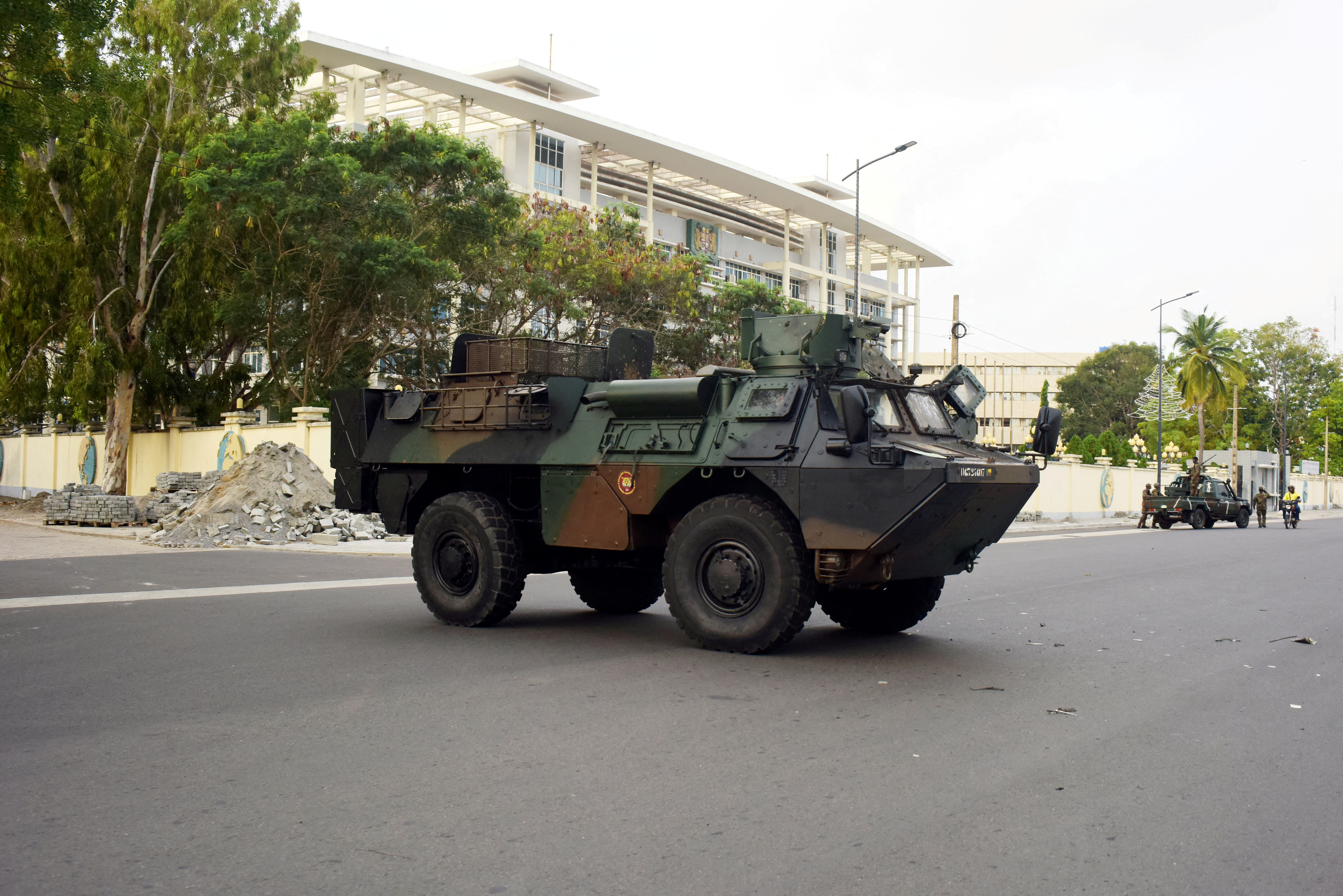 FILE PHOTO: Military armoured vehicles take position in front of the headquarters of Benin's radio and television station, a day after the country's armed forces thwarted the attempted coup against the government of Benin's President Patrice Talon, in Cotonou, Benin, December 8, 2025. REUTERS/Charles Placide Tossou/File Photo