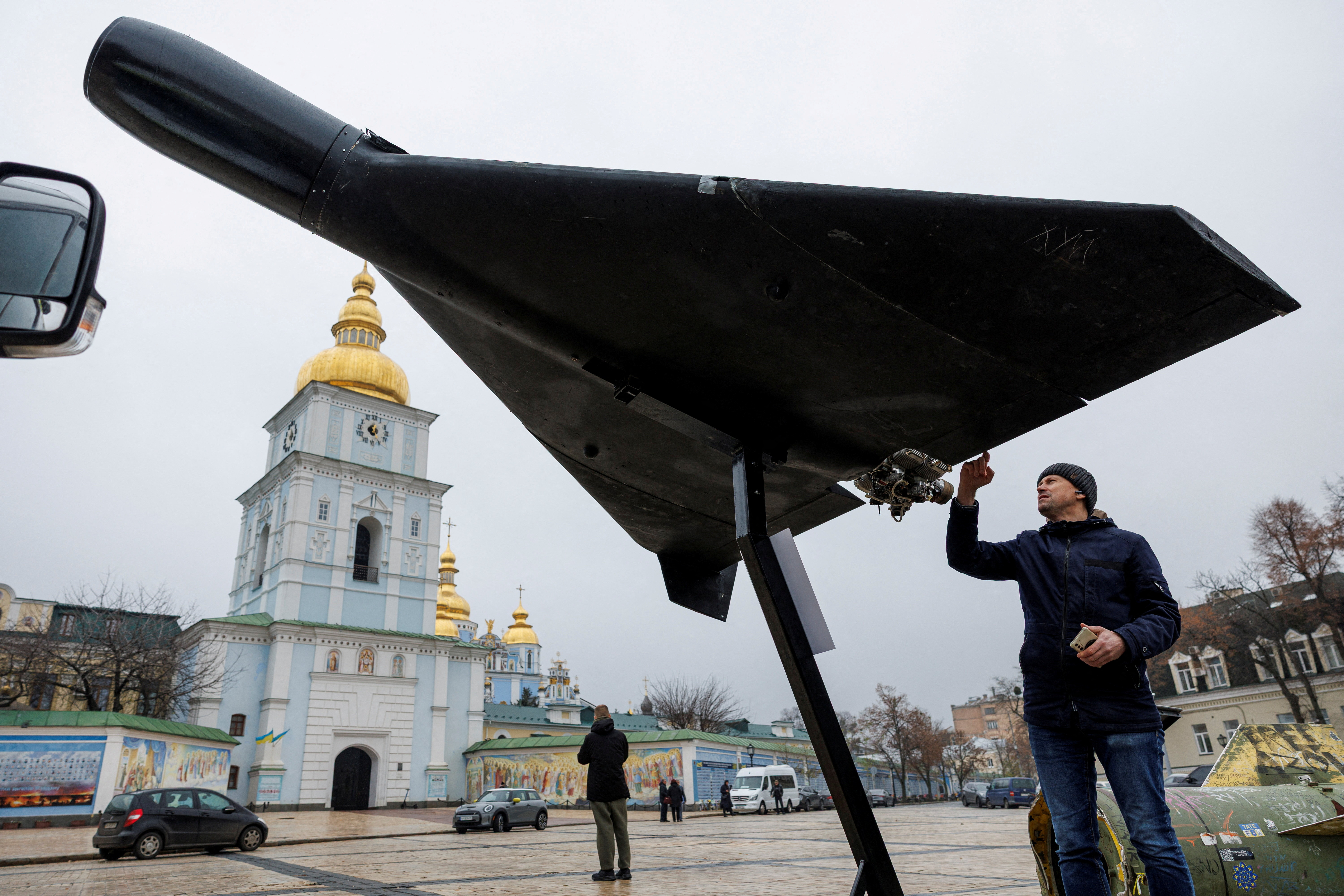 FILE PHOTO: A resident touches a Russian-Iranian Shahed-136 (Geran-2) kamikaze drone installed in front of Saint Michael's Cathedral as a part of an exhibition displaying destroyed Russian military vehicles and weapons, amid Russia's attack on Ukraine, in Kyiv, Ukraine November 26, 2025. REUTERS/Valentyn Ogirenko/File Photo