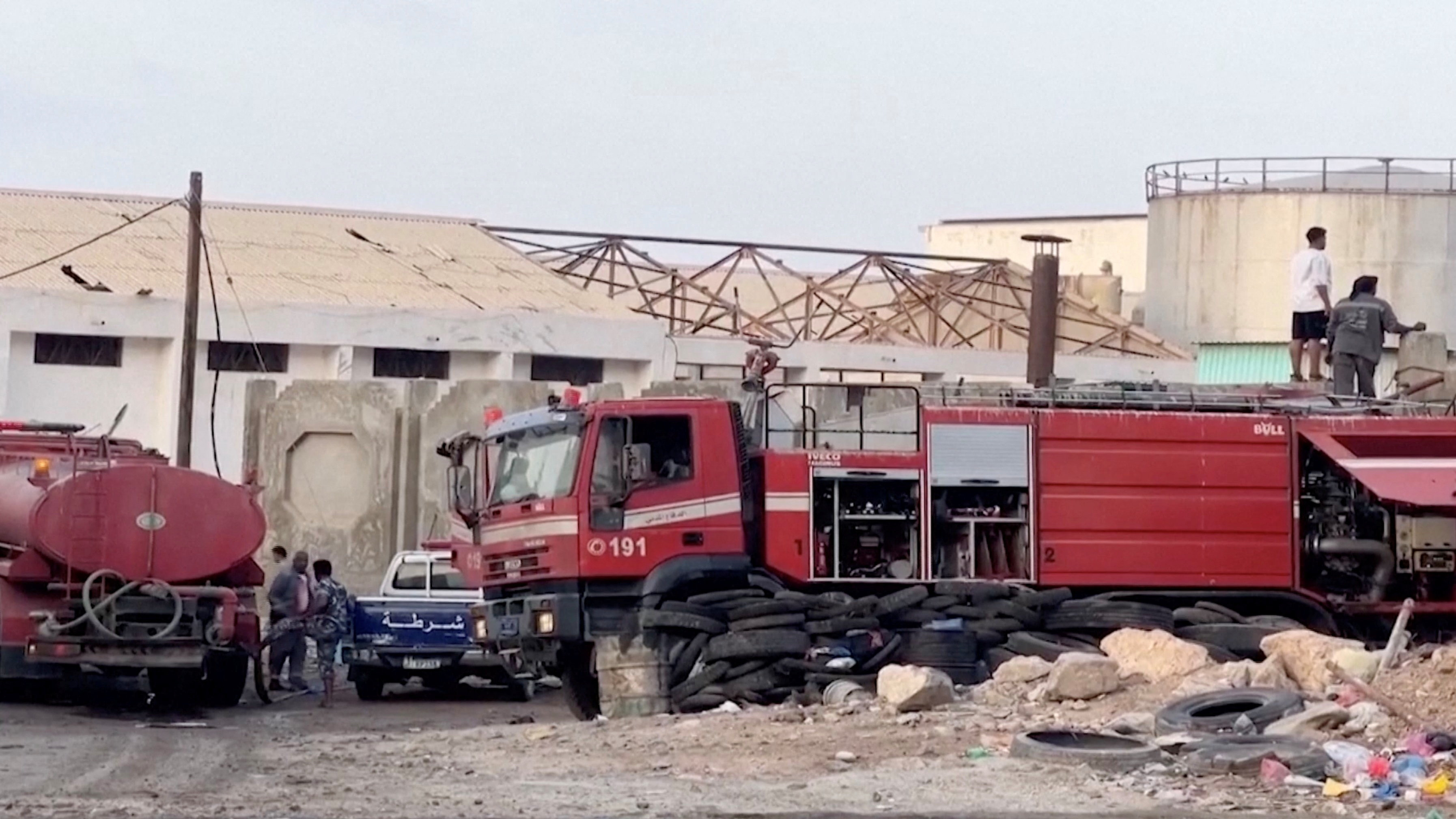 Emergency responders work on the site of a Saudi-led coalition airstrike, which targeted what it described as foreign military support to UAE-backed southern separatists, in Yemen's southern port of Mukalla, in this screengrab from a handout video obtained by Reuters on December 30, 2025. Aden al-Mustakillah TV/Handout via REUTERS THIS IMAGE HAS BEEN SUPPLIED BY A THIRD PARTY Verification lines: Storage tanks, warehouses and trees matched satellite images and corroborating footages. Date verified by official and media reports.