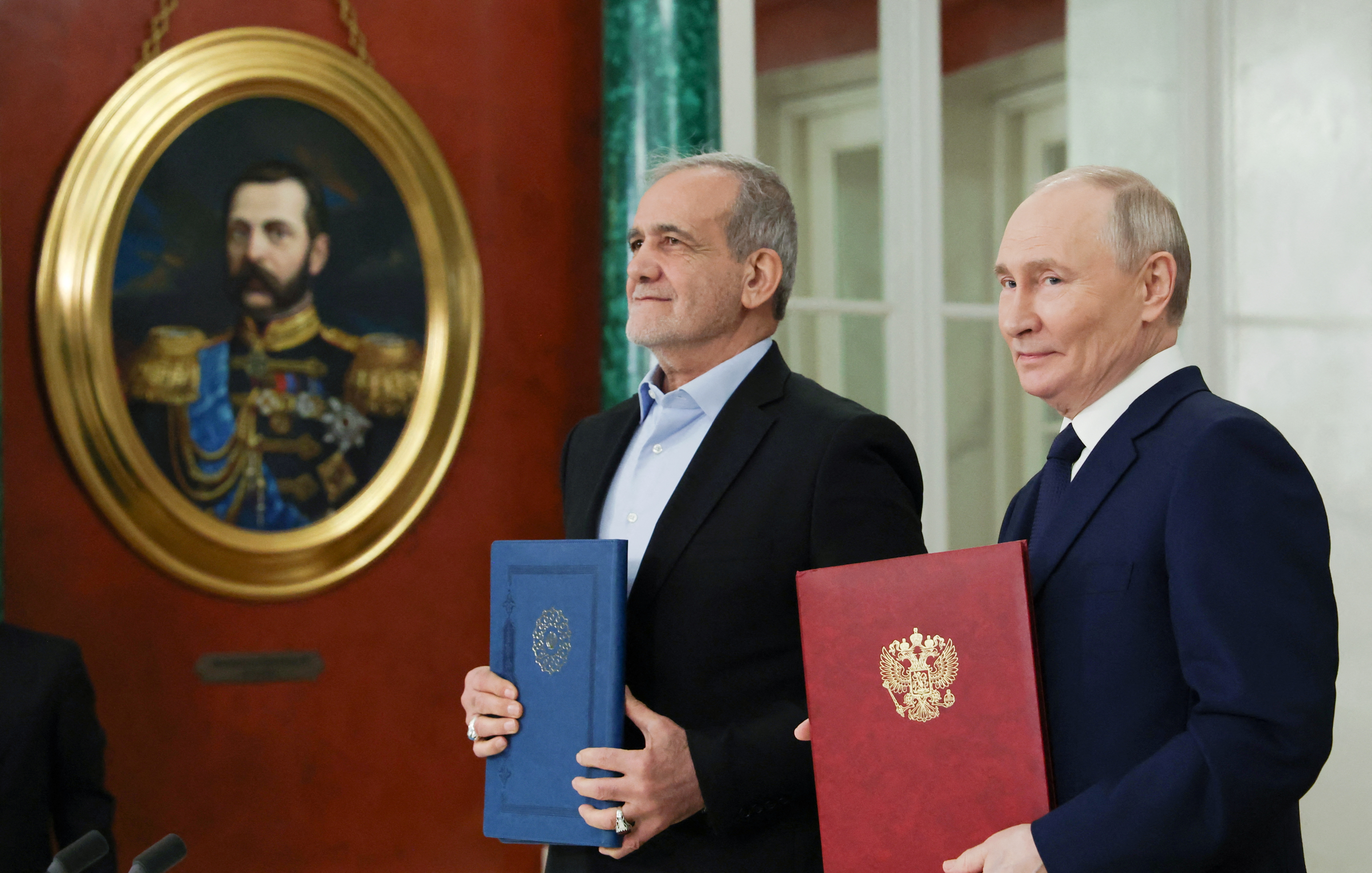 Russian President Vladimir Putin and Iranian President Masoud Pezeshkian attend a ceremony to sign an agreement of comprehensive strategic partnership between the two countries, at the Kremlin in Moscow, Russia January 17, 2025. Sputnik/Vyacheslav Prokofyev/Pool via REUTERS ATTENTION EDITORS - THIS IMAGE WAS PROVIDED BY A THIRD PARTY.