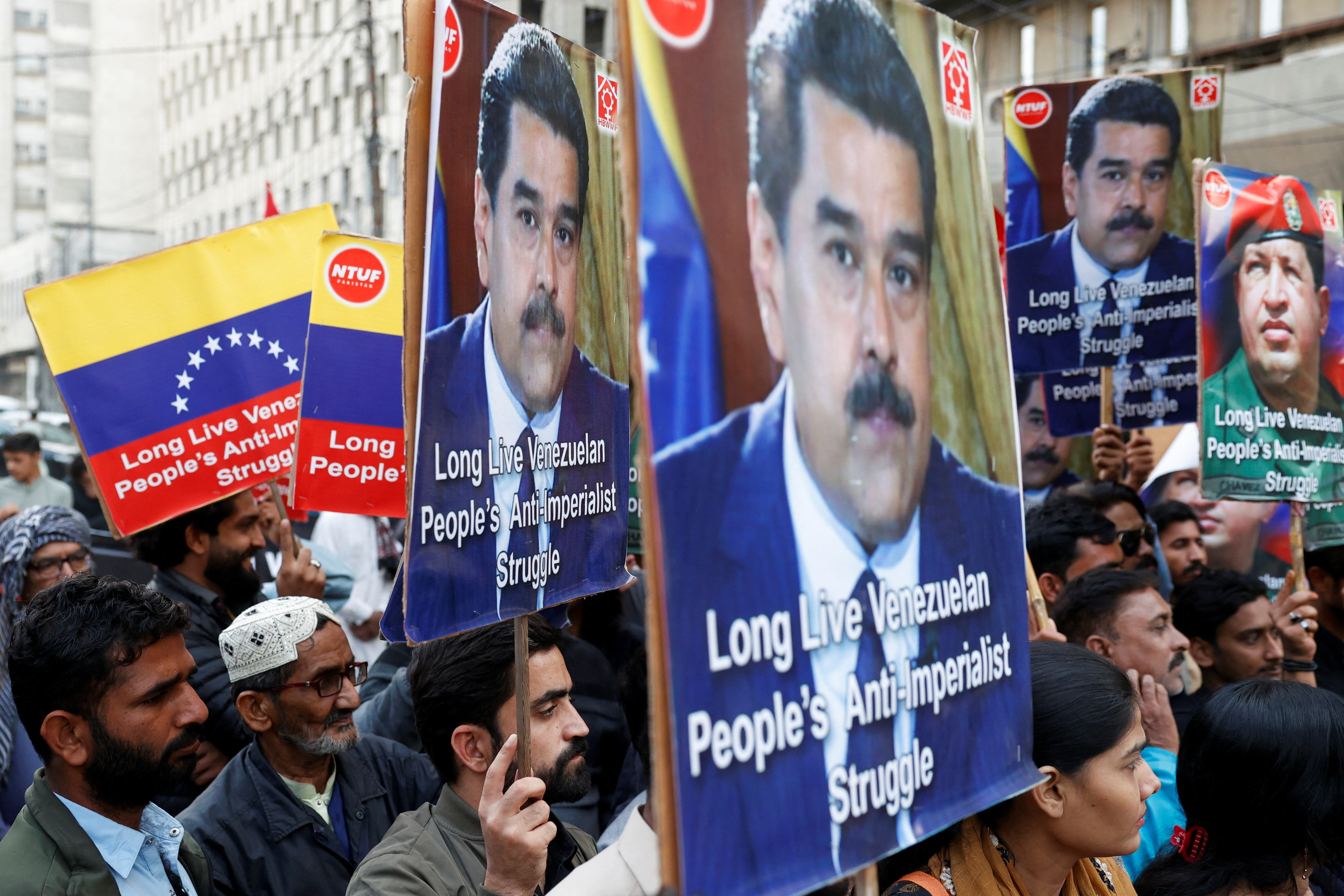 People carry placards as they rally to condemn the U.S. strikes on Venezuela and the capture of Venezuelan President Nicolas Maduro