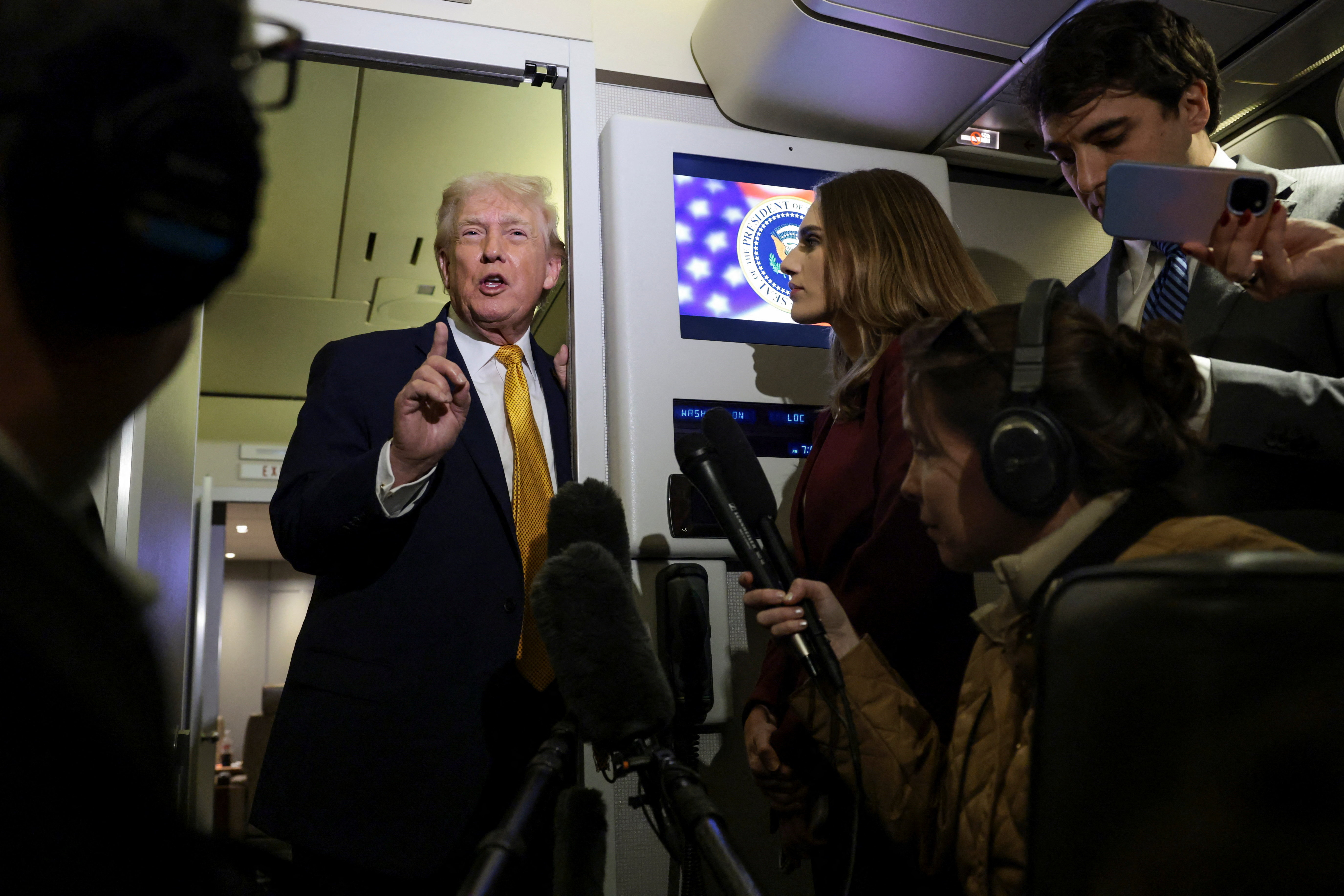 U.S. President Donald Trump speaks to reporters aboard Air Force One en route from Florida to Joint Base Andrews, Maryland, U.S., January 4, 2026. REUTERS/Jonathan Ernst