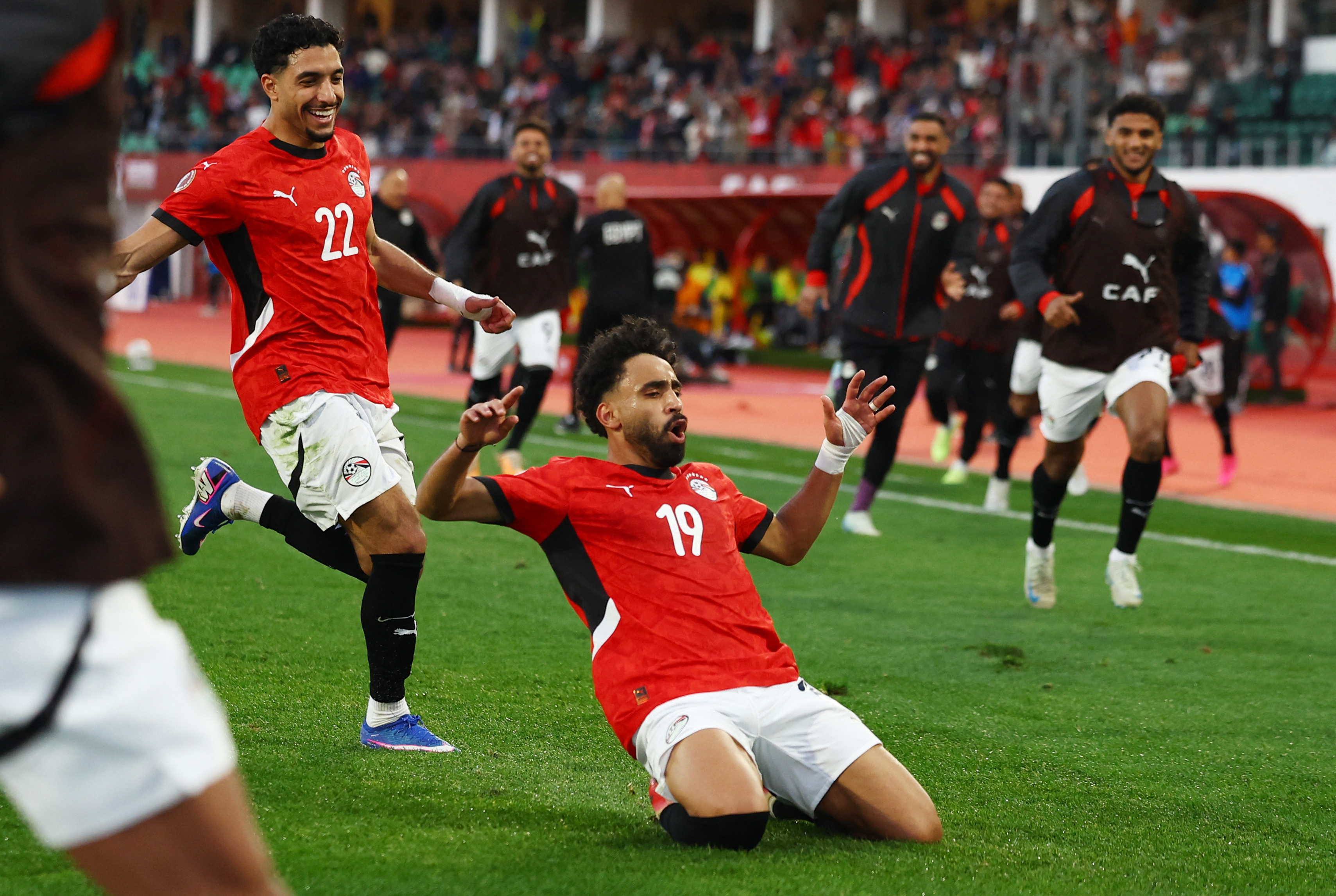 Egypt's Marwan Attia celebrates scoring their first goal with Omar Marmoush