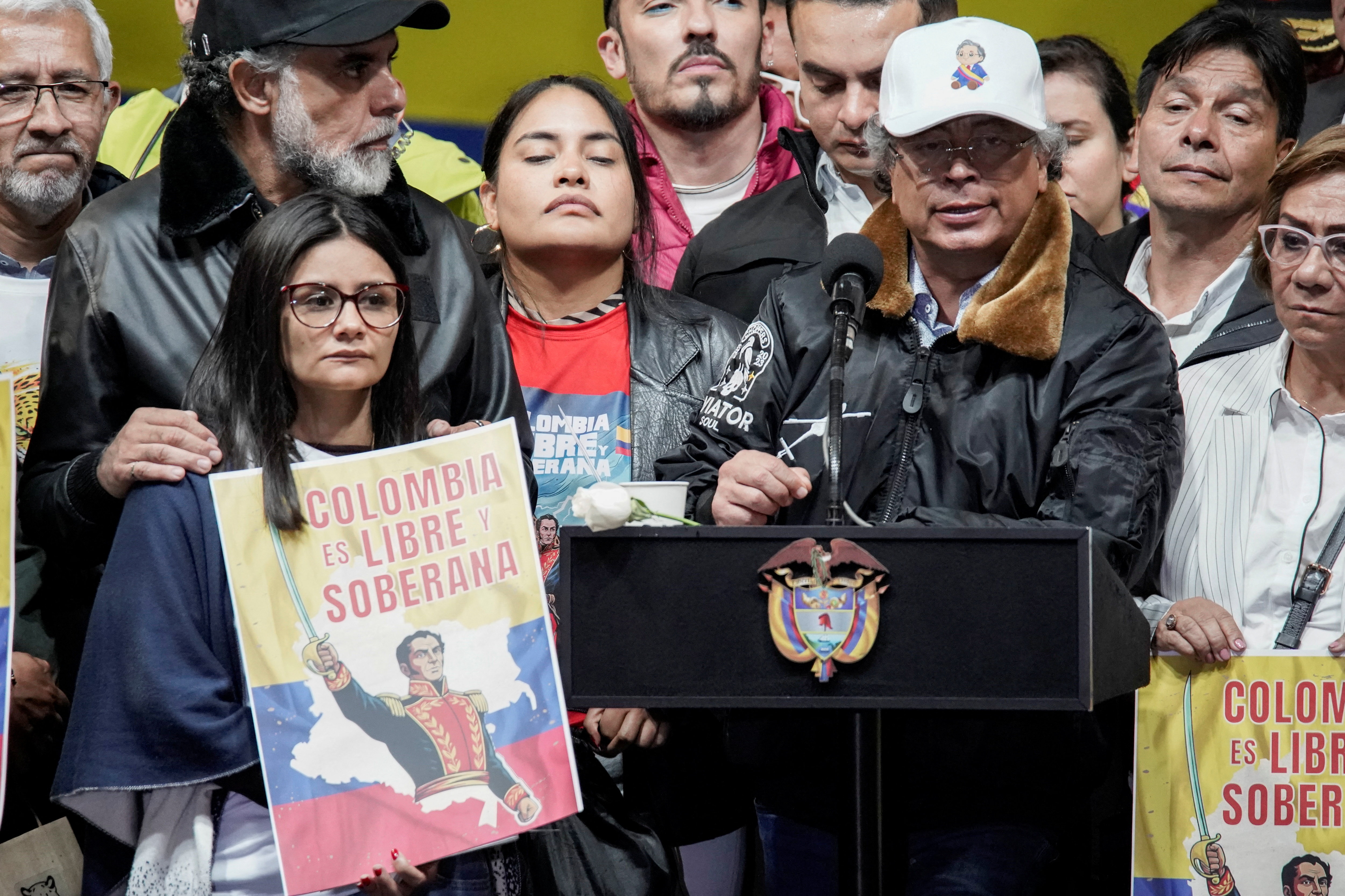 Colombian President Gustavo Petro, flanked by supporters holding posters with the picture of South American independence leader Simon Bolivar, speaks during a rally in defense of national sovereignty.