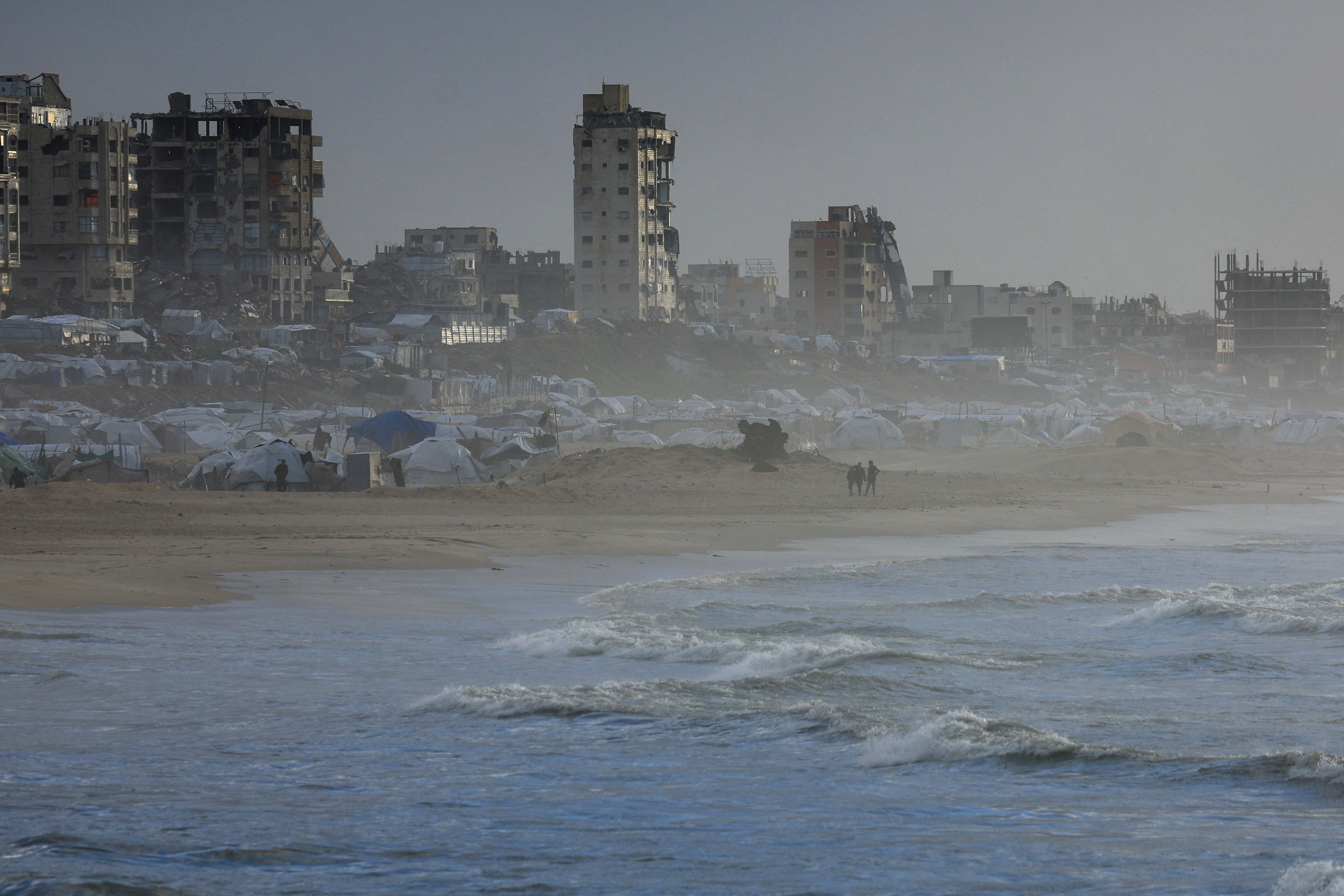 Wind hits tents on the beach.