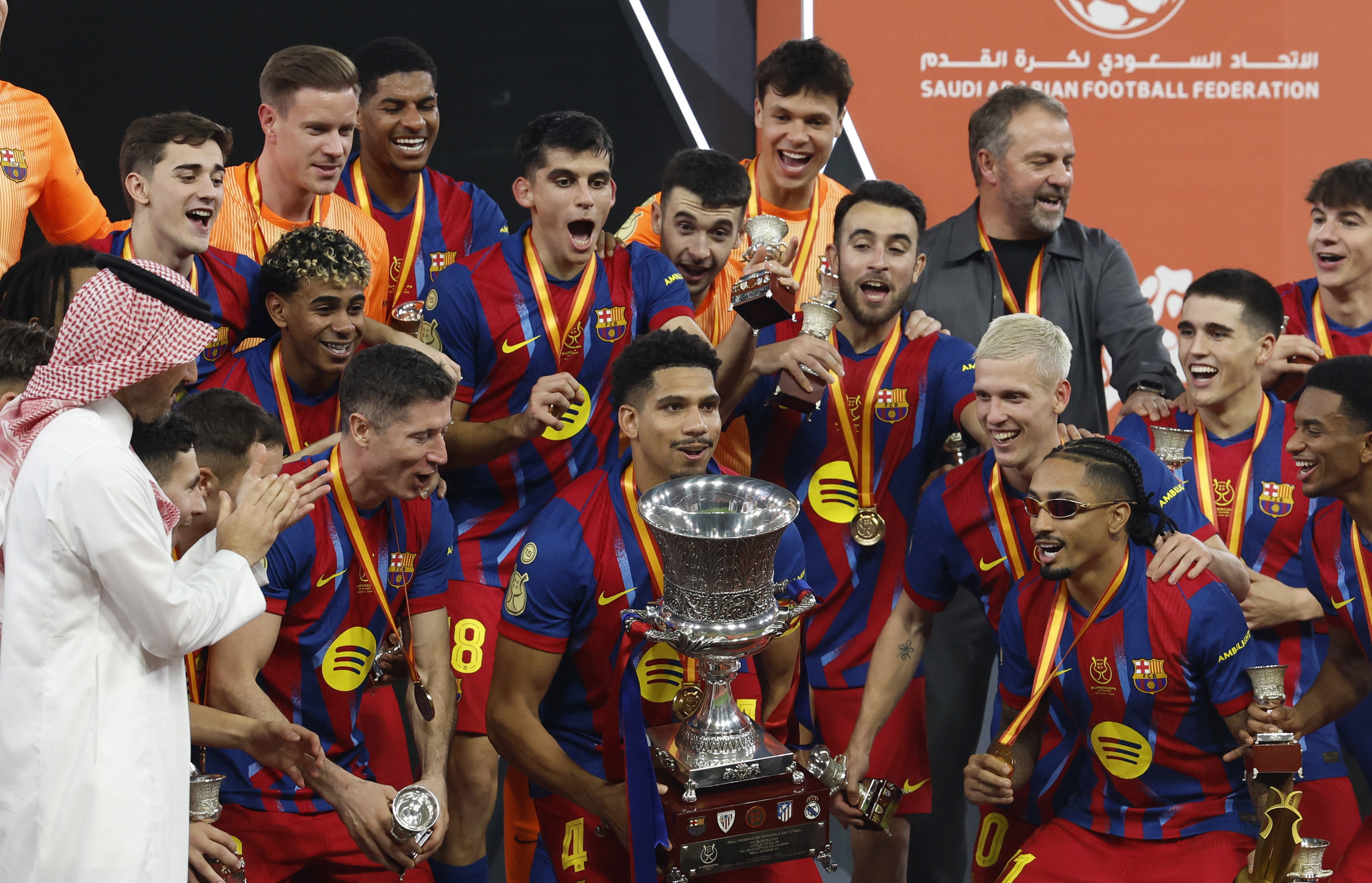 Barcelona's Ronald Araujo lifts the trophy with teammates after winning the Spanish Super Cup final