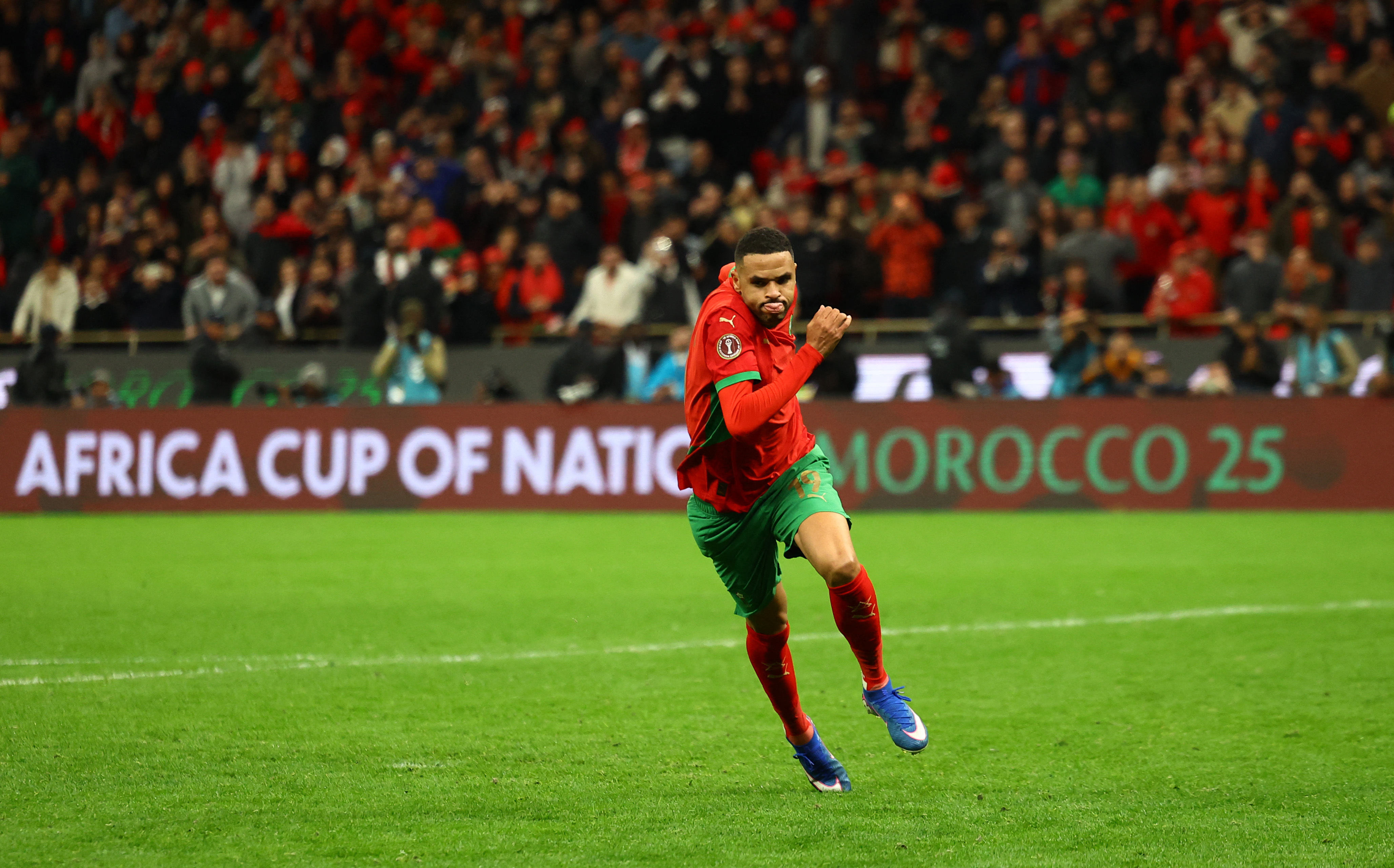 Morocco's Youssef En-Nesyri reacts after scoring his penalty to win the penalty shootout