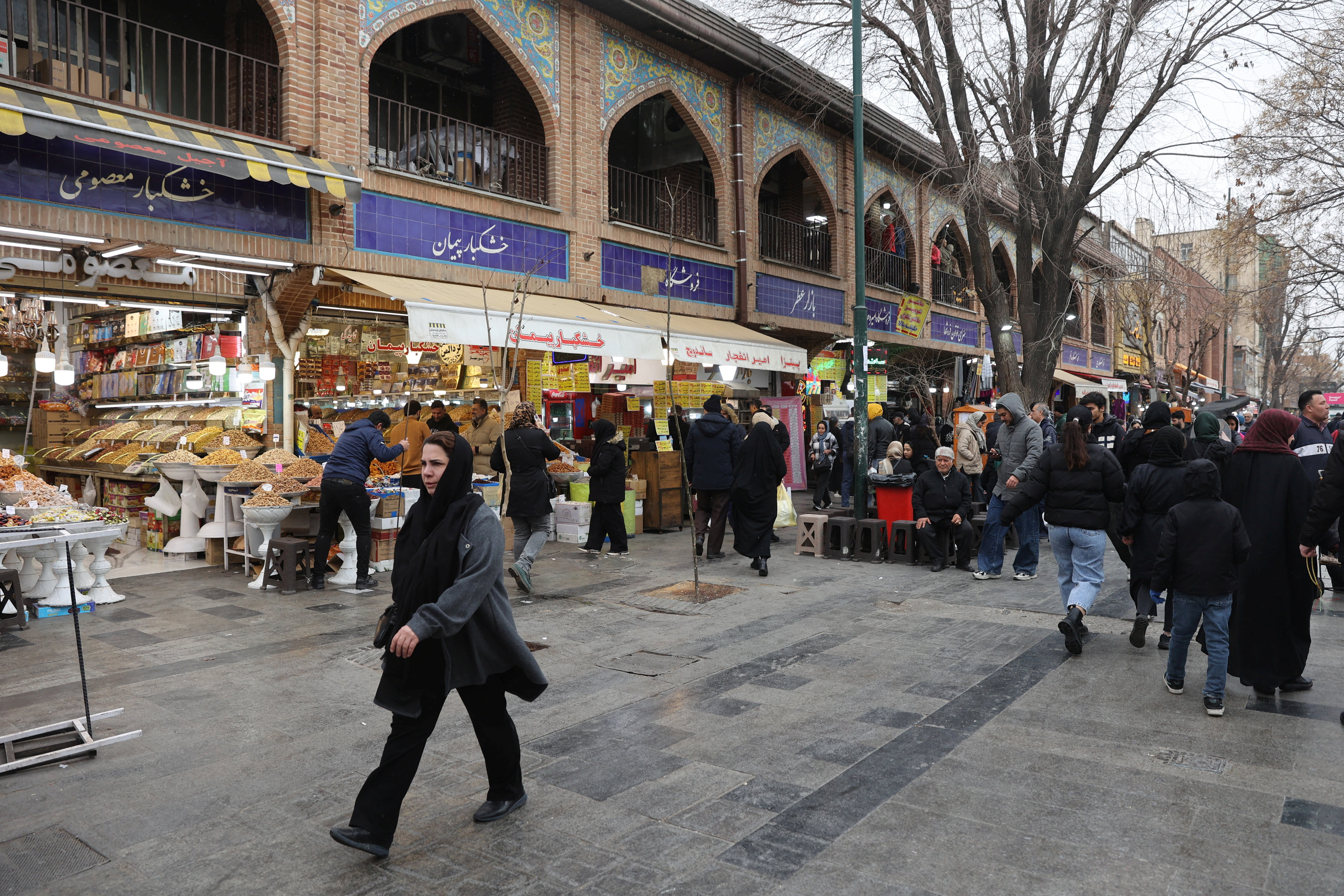 People walk in Tehran