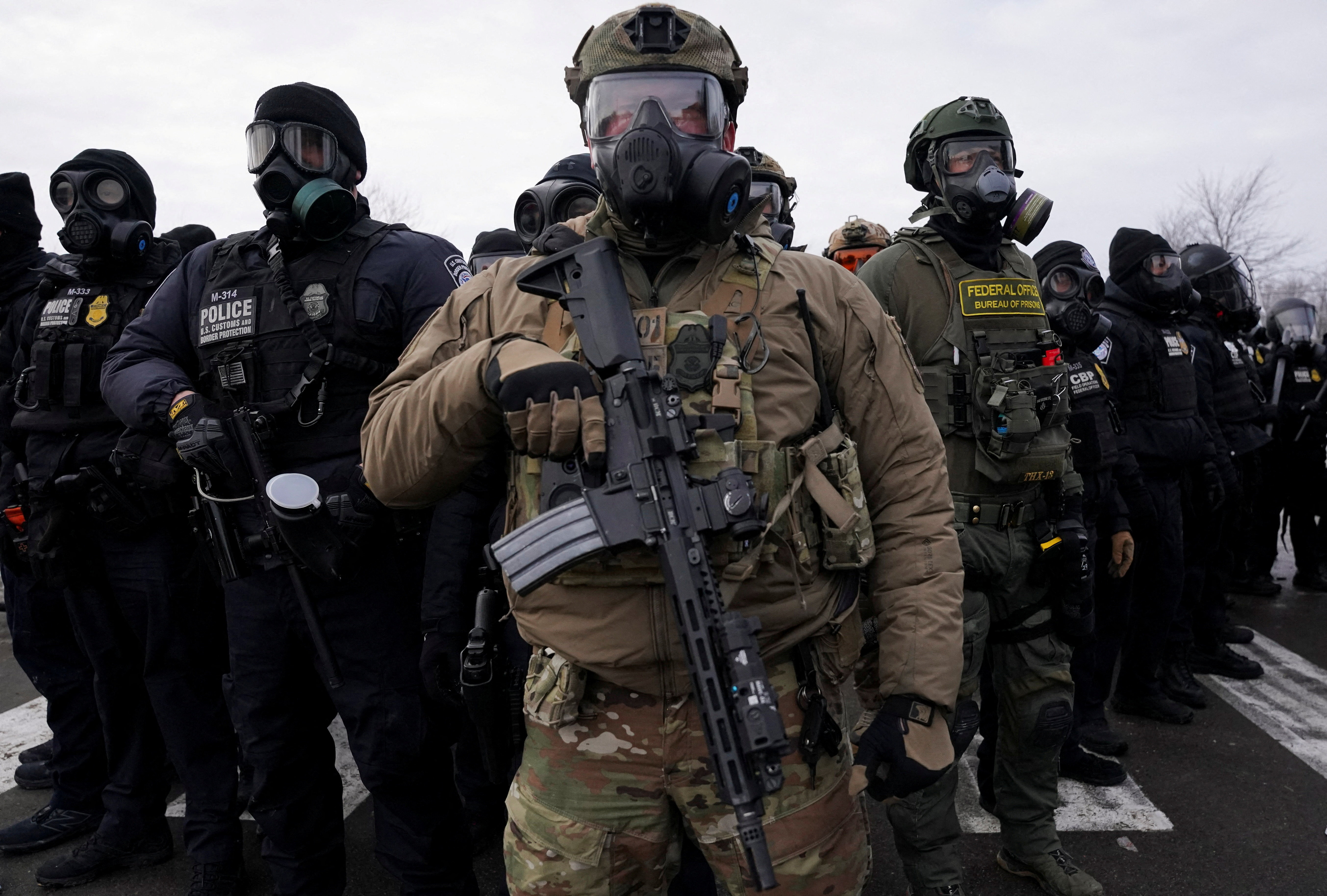 Members of U.S. Customs and Border Protection (CBP) and other law enforcement officials stand guard, in front of the Bishop Henry Whipple Federal Building, during a protest more than a week after an ICE agent fatally shot Renee Nicole Good, in Minneapolis, Minnesota, U.S., January 17, 2026. REUTERS/Seth Herald TPX IMAGES OF THE DAY