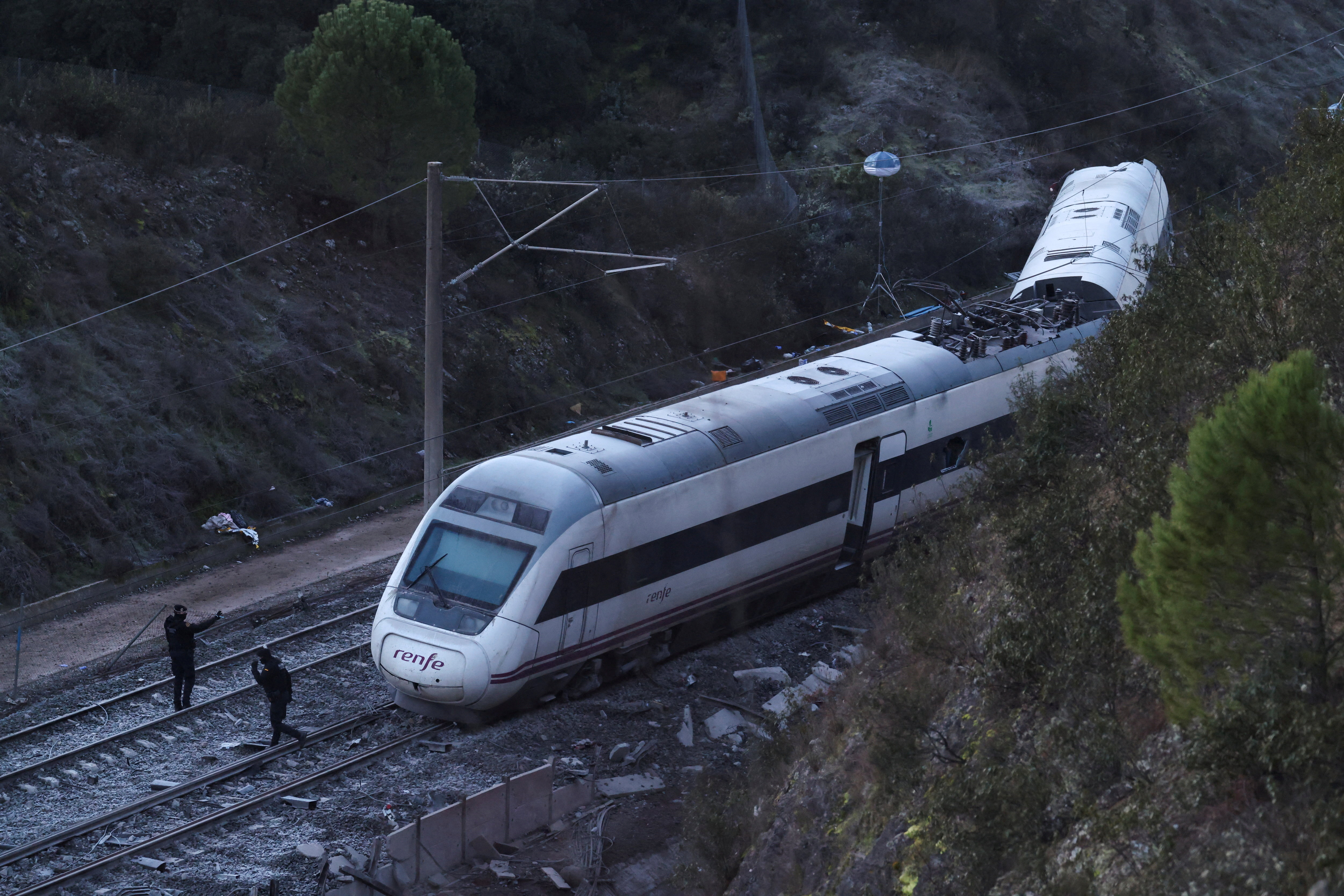 Members of the Spanish Civil Guard work next to one of the trains involved in the accident, at the site of a deadly derailment of two high-speed trains near Adamuz, in Cordoba, Spain, January 19, 2026. REUTERS/Susana Vera TPX IMAGES OF THE DAY