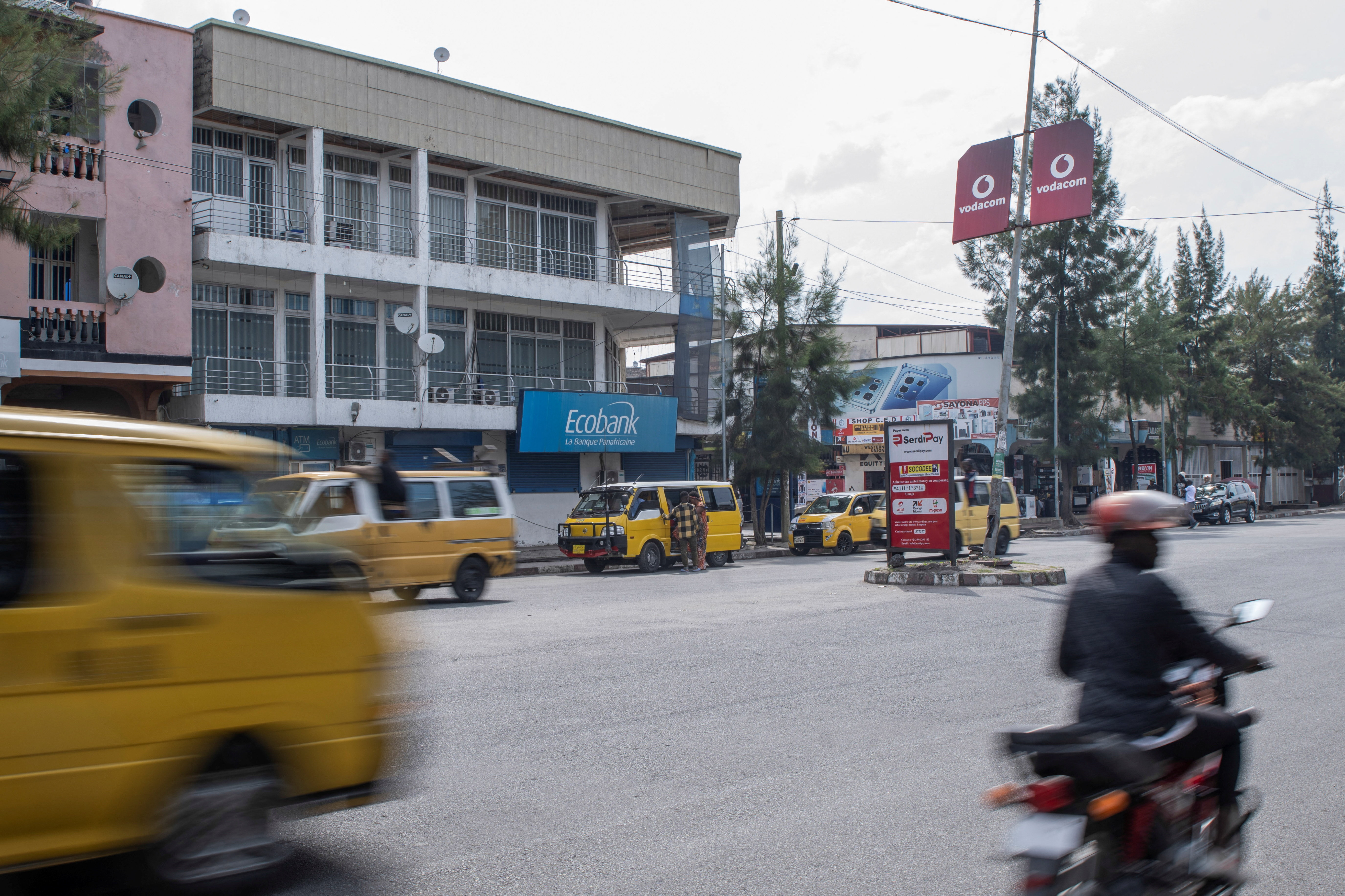 Motorists drive past a closed branch of Ecobank.