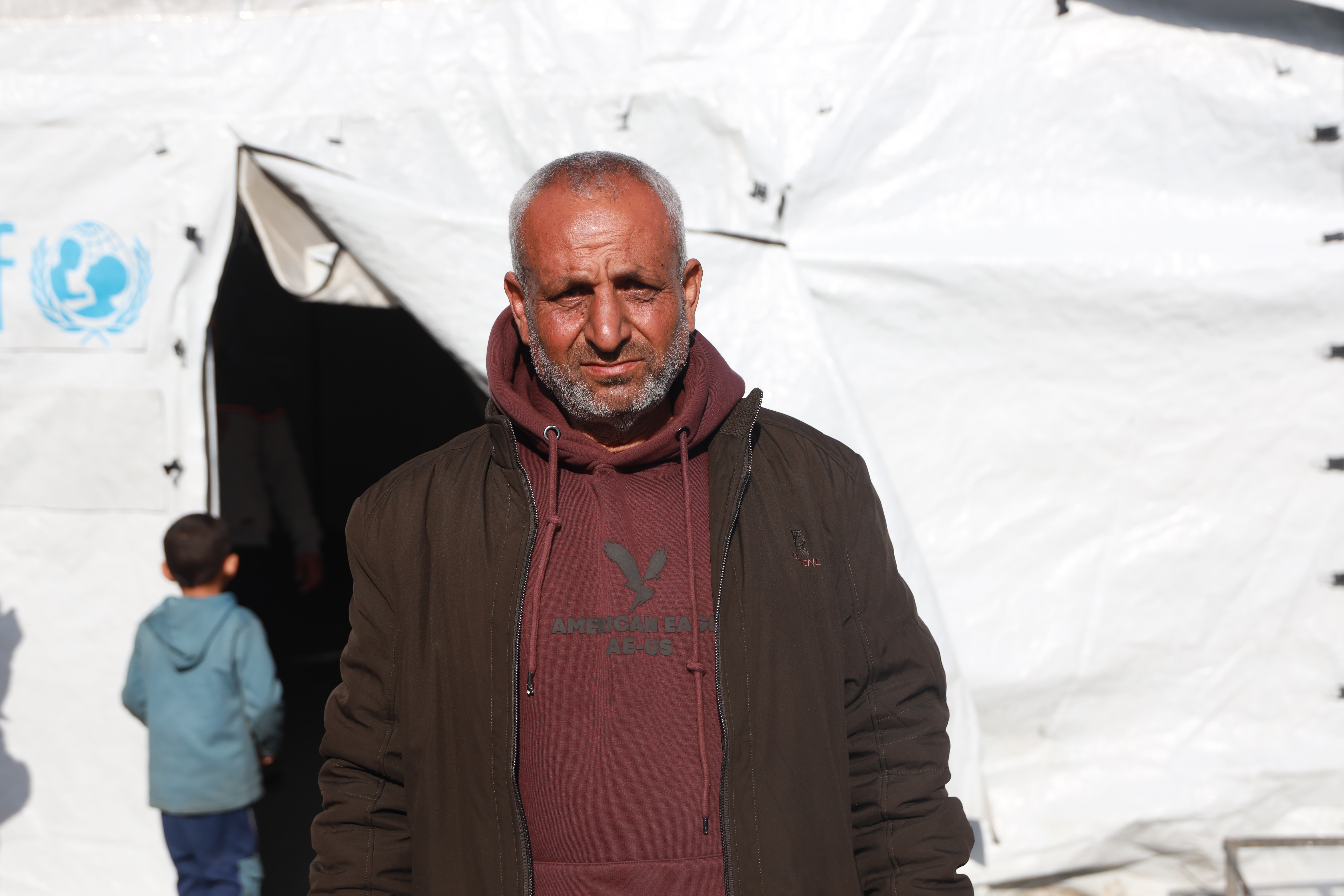 Man stands in front of tent 