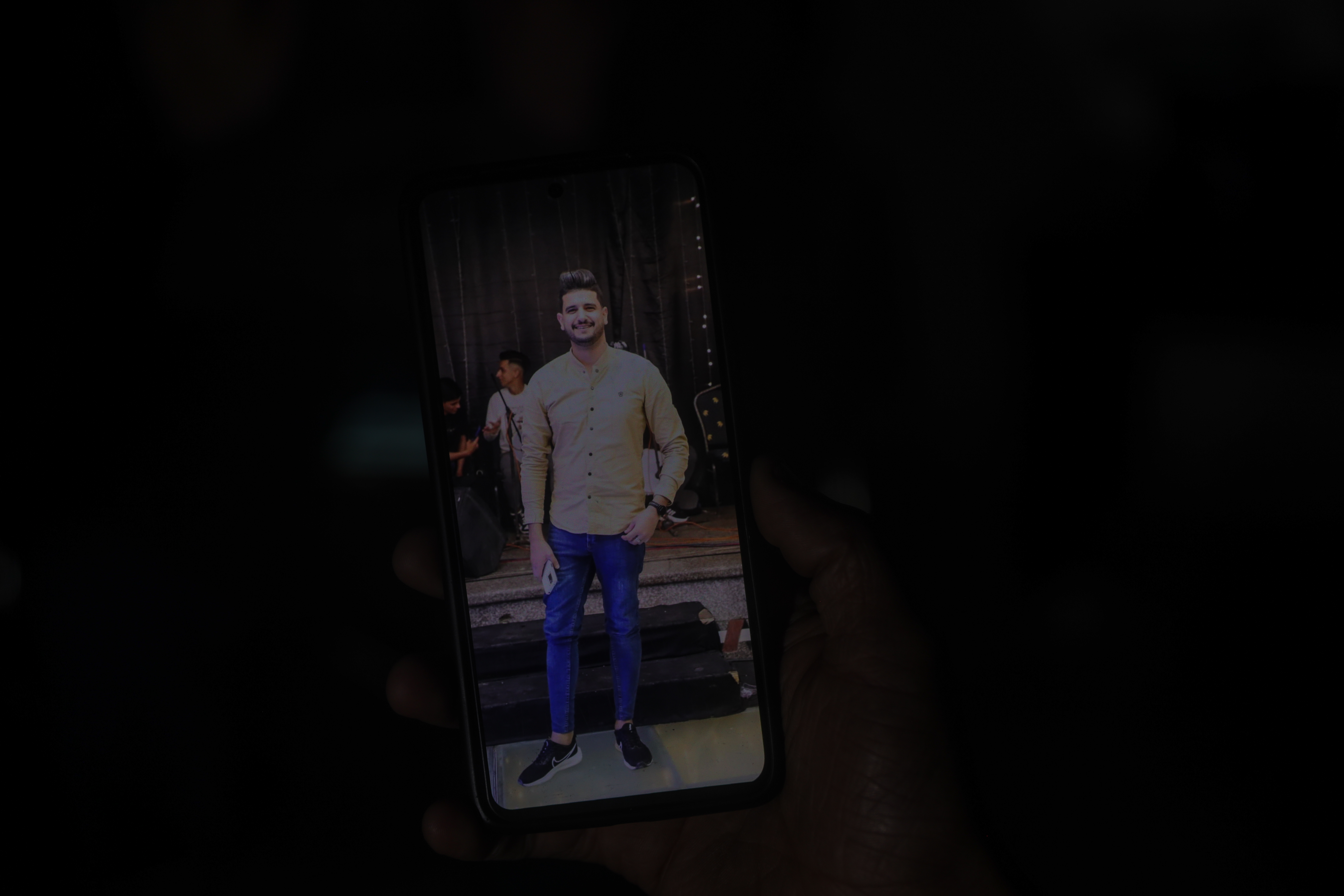 Picture of Abdullah Nattat on a phone standing