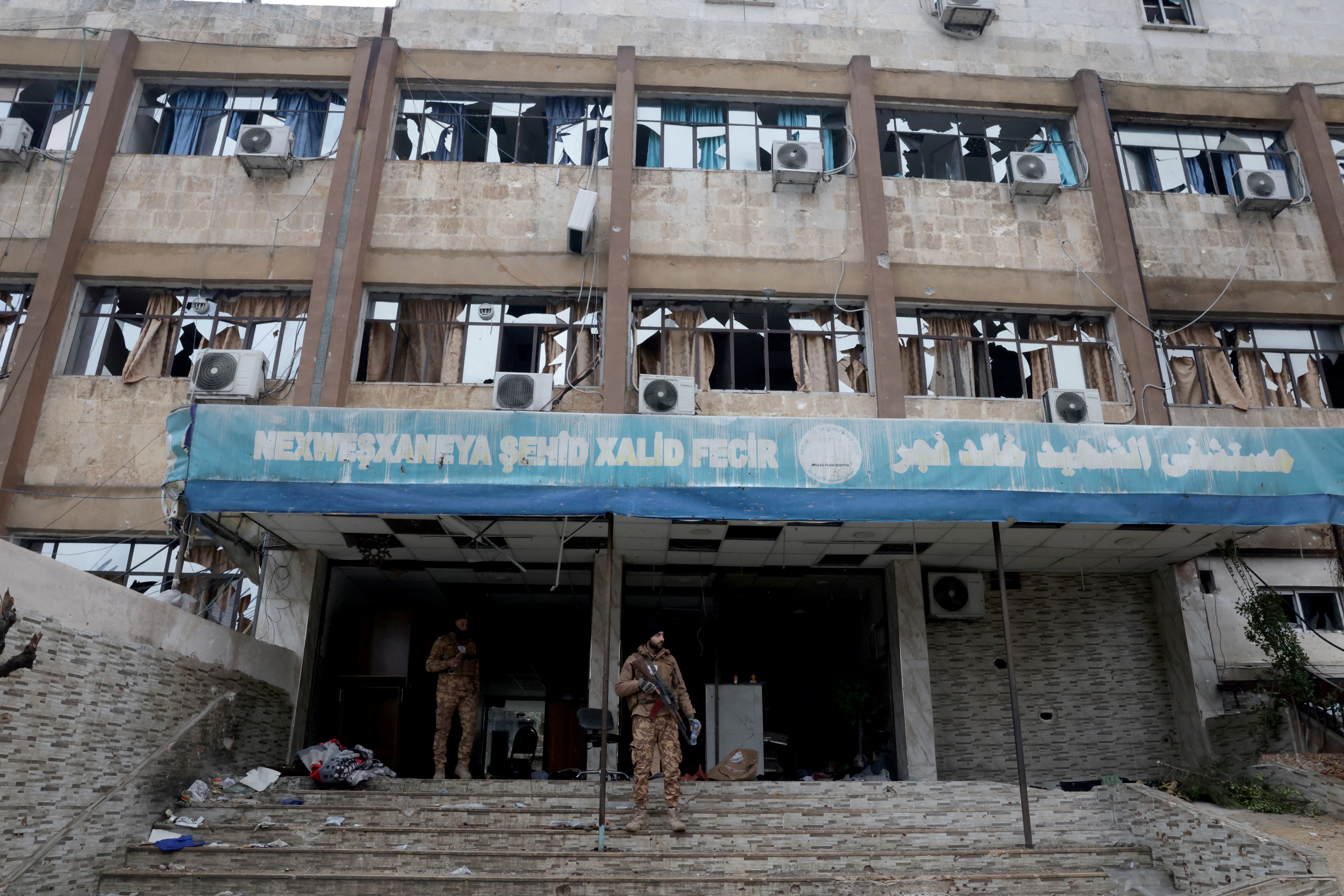 Syrians in Kurdish area of Aleppo pick up pieces after clashes