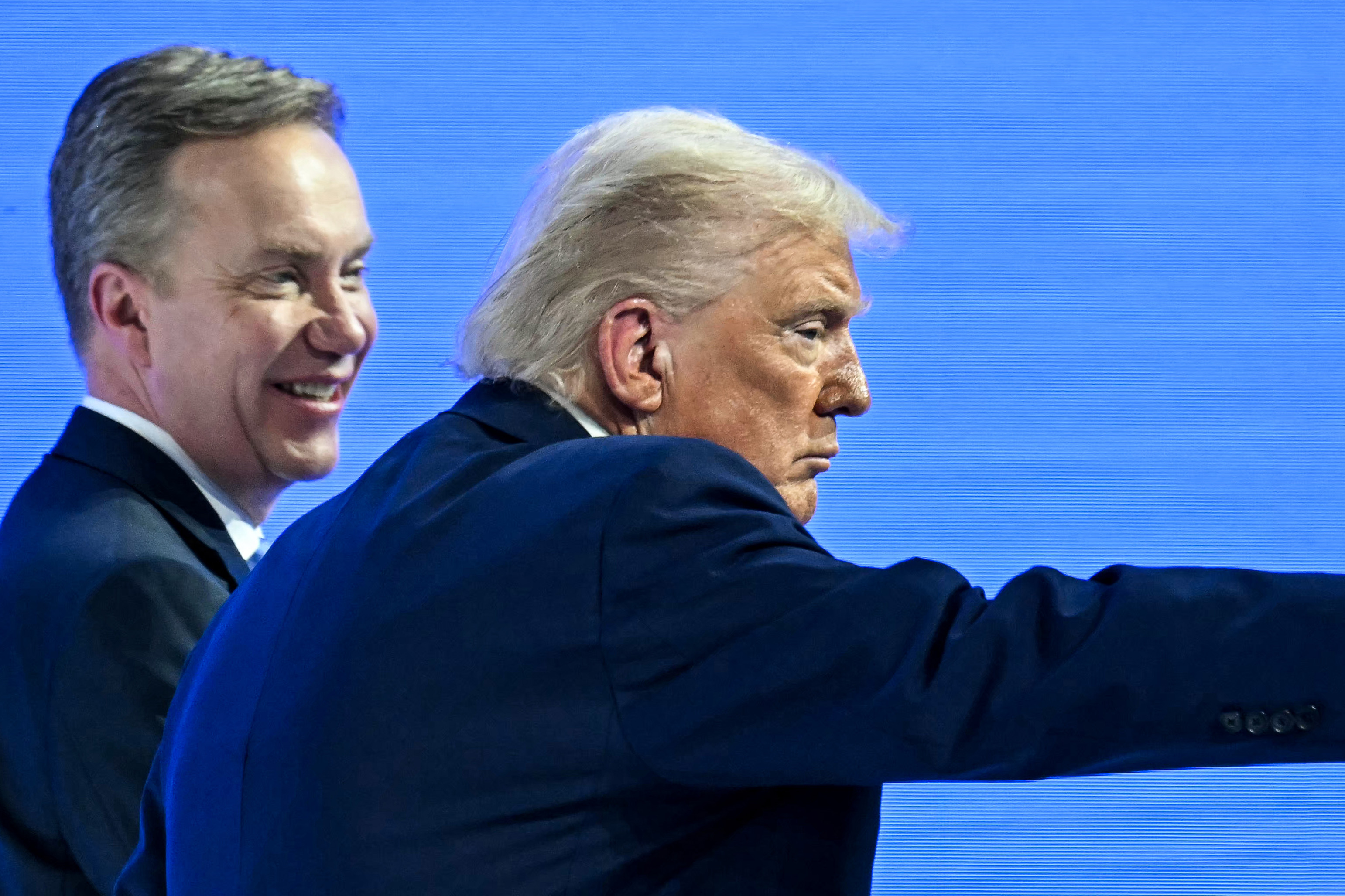 US President Donald Trump gestures flanked by World Economic Forum president and CEO Borge Brende during the World Economic Forum (WEF) annual meeting in Davos on January 21, 2026. [Fabrice Coffrini/AFP]
