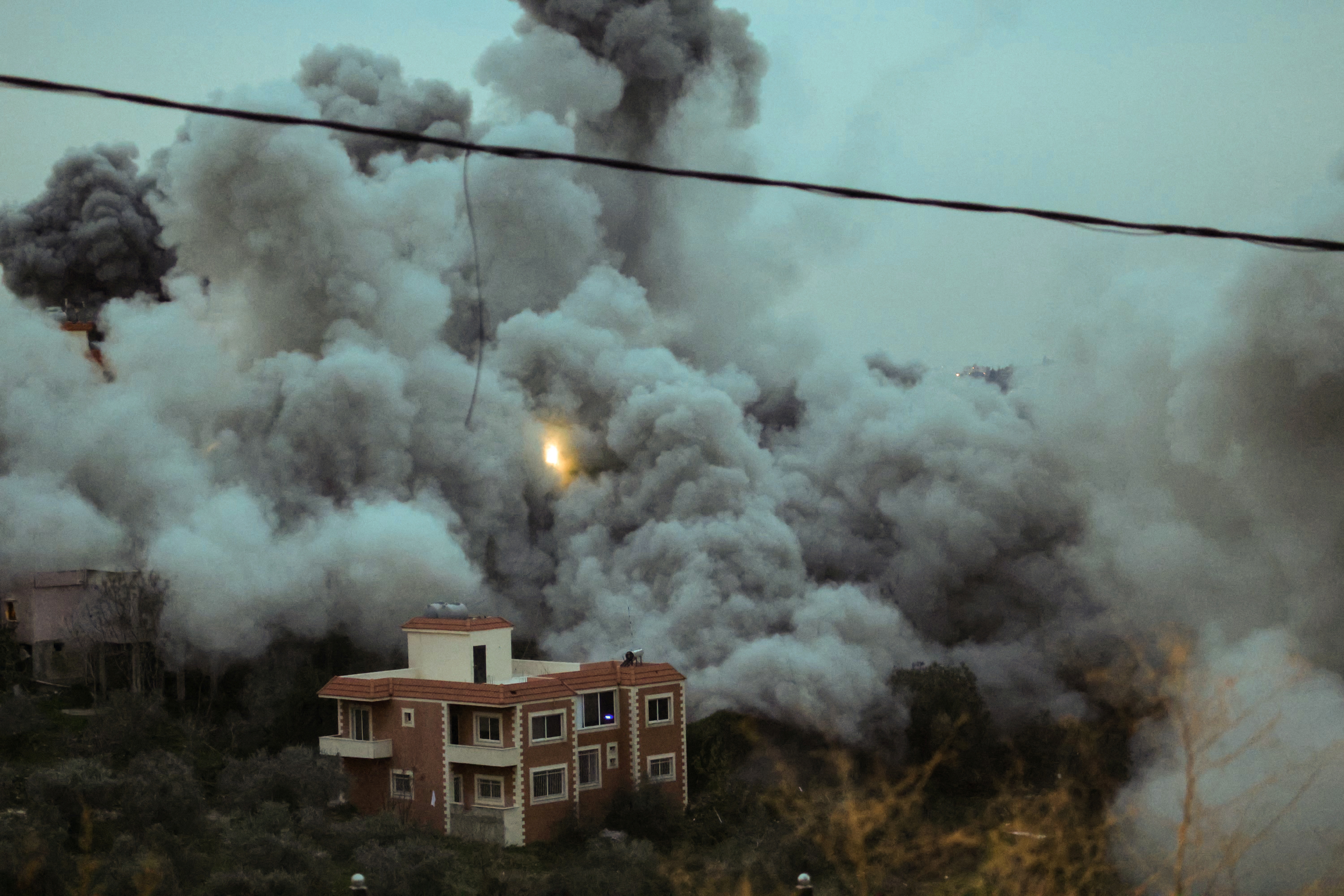 Smoke and sparks ascend from the site of an Israeli airstrike that targeted a building in the southern Lebanese village of Al-Kfour on January 21, 2026. Israel has kept up regular strikes in Lebanon despite the November 2024 truce that sought to end more than a year of hostilities with Hezbollah, usually saying it is targeting members of the Iran-backed group or its infrastructure. (Photo by Rabih DAHER / AFP)