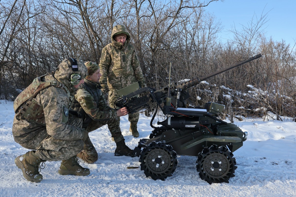 TOPSHOT - This handout photograph taken and released on January 26, 2026, by the press service of the 65th Mechanized Brigade of Ukrainian Armed Forces shows servicemen testing a M2 Browning 50-caliber machine gun installed on an unmanned ground vehicle at an undisclosed location in Zaporizhzhia region, amid the Russian invasion of Ukraine. (Photo by Andriy Andriyenko / 65th Mechanized Brigade of Ukrainian Armed Forces / AFP) / RESTRICTED TO EDITORIAL USE - MANDATORY CREDIT "AFP PHOTO / HANDOUT / ANDRIY ANDRIYENKO /65TH MECANIZED BRIGADE OF UKRAINE ARMED FORCES" - NO MARKETING NO ADVERTISING CAMPAIGNS - DISTRIBUTED AS A SERVICE TO CLIENTS