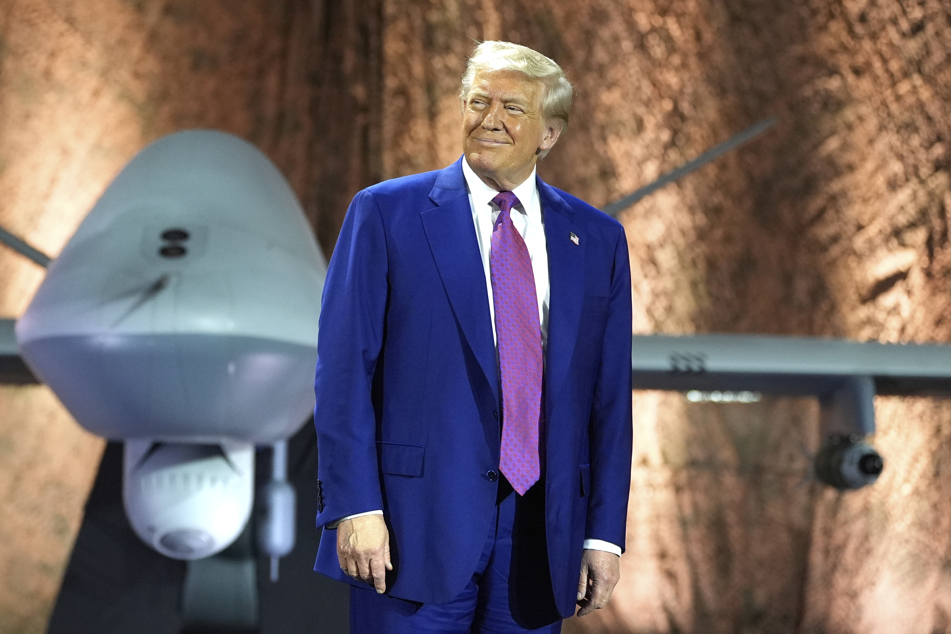 Trump poses in front of MQ-9 Reaper drone