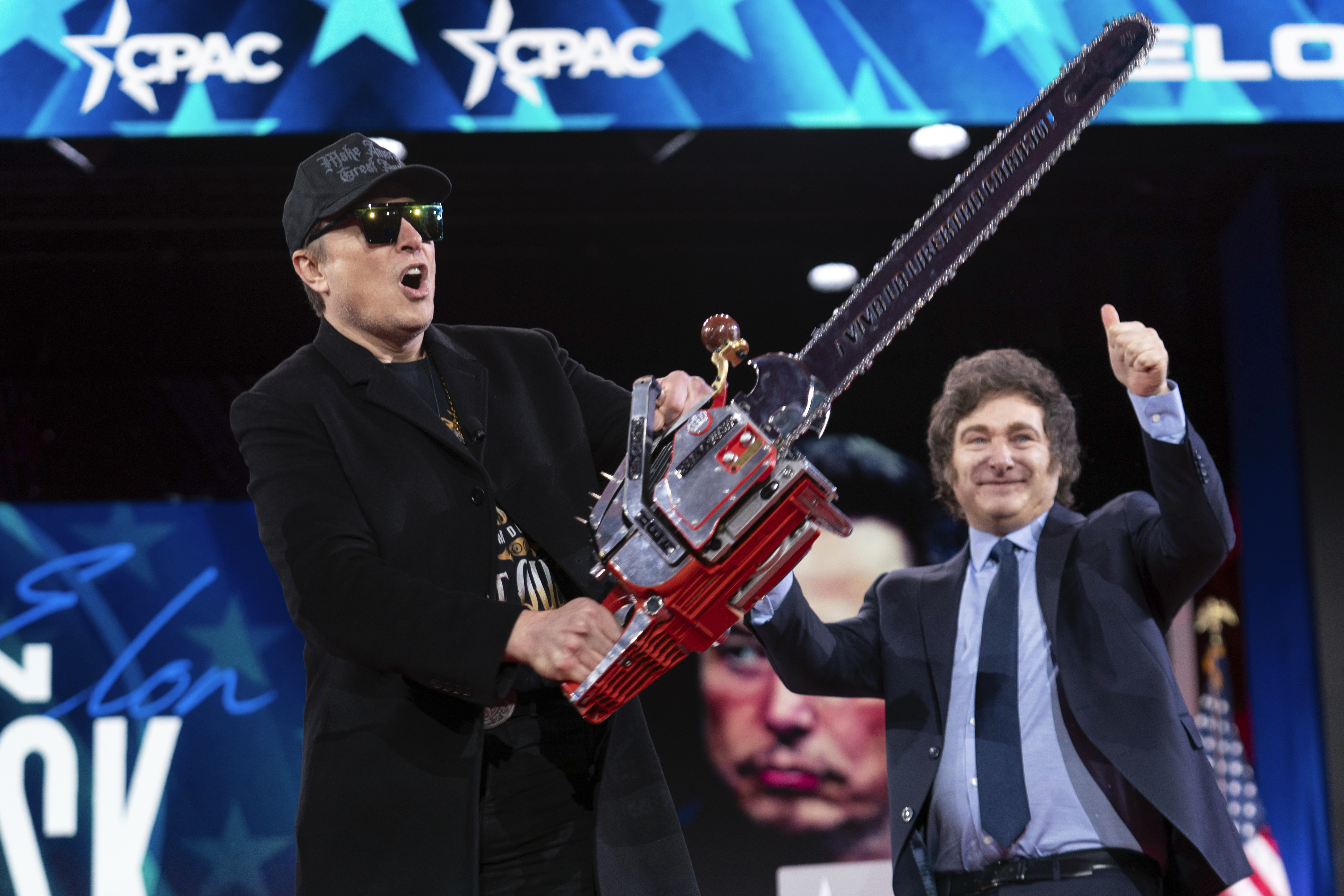 Javier Milei presents Elon Musk with a chainsaw on stage at CPAC