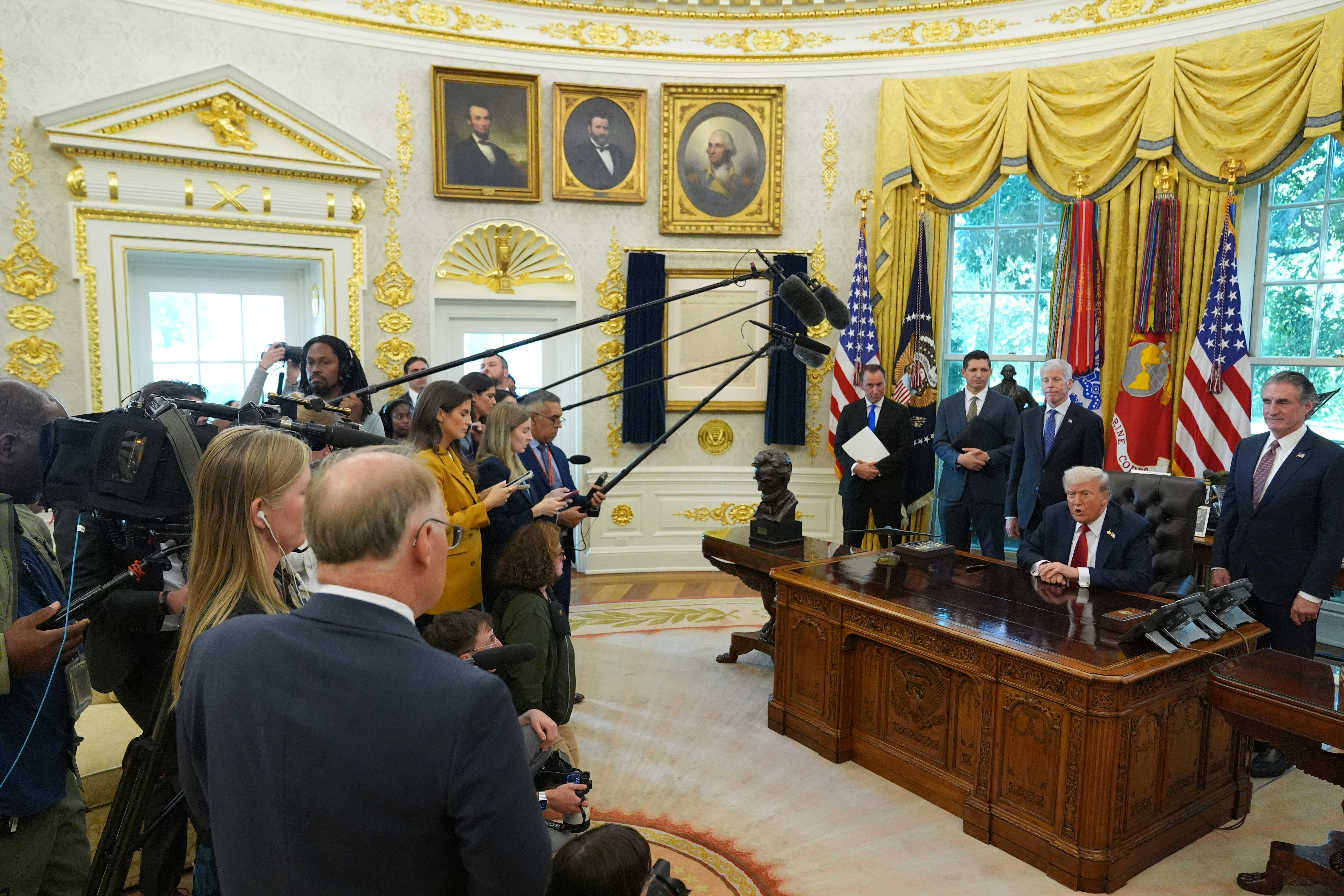 Trump speaks to reporters in the Oval Office