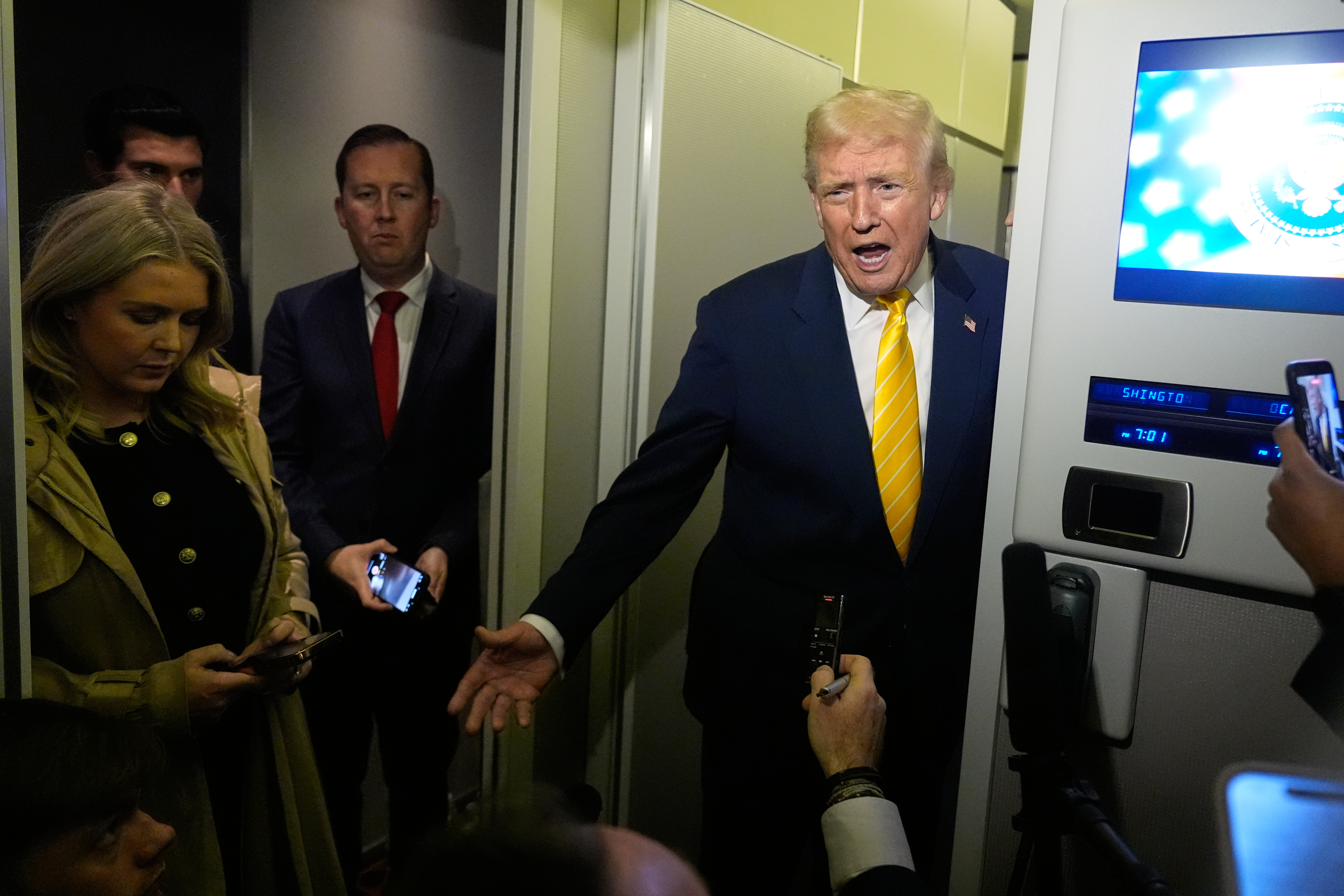 Trump talks to reporters on Air Force One.